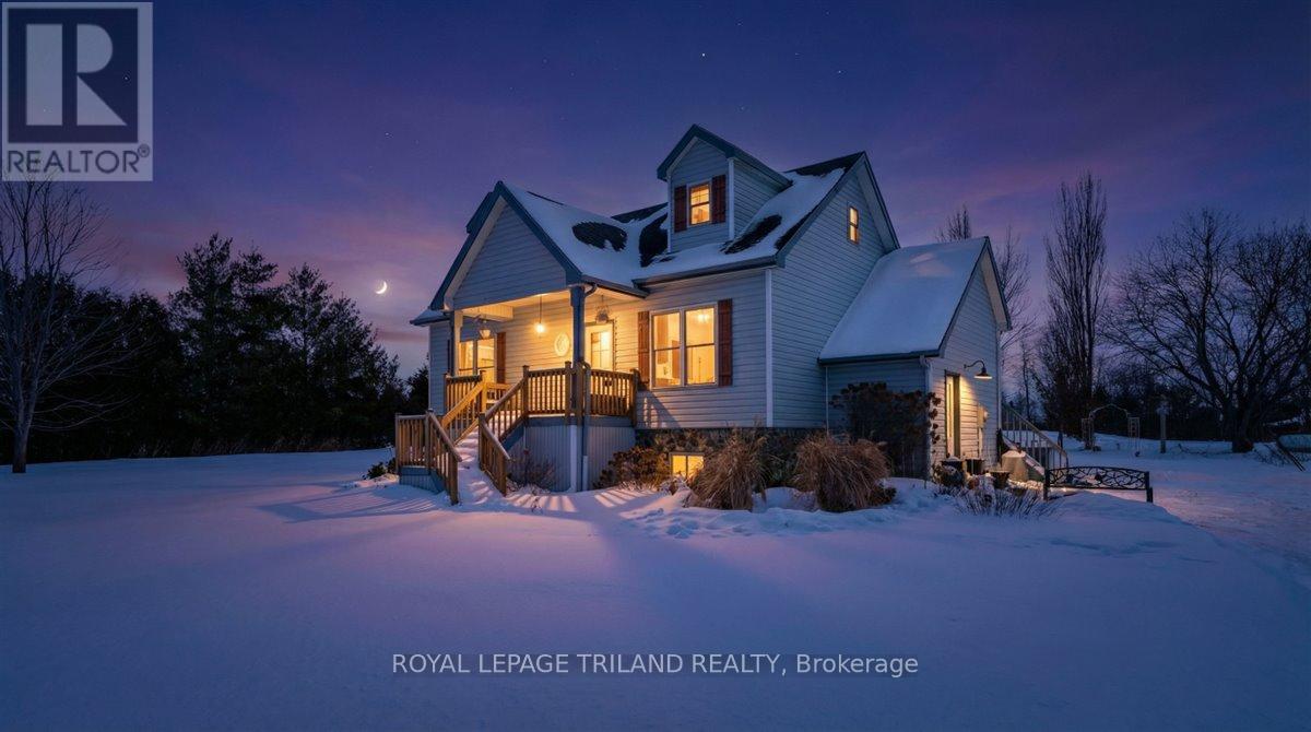 Country Comfort Just Minutes from Town   Enjoy the best of country living with the convenience of being just 2 minutes from the 402 in this welcoming 1.5-storey home, offering 3 or 4 bedrooms, 3 bathrooms, and approximately 2118 sq ft of interior living space. Move-in ready and well cared for.Set on 1.392 acres on a paved road, the home backs onto open land and offers sweeping panoramic views from the front and back. A beautiful front pond with waterfall and a charming front porch create a peaceful first impression as you arrive.  Inside, the main floor features a large, bright kitchen that opens to the dining area, with direct access to the 2-tiered deck-ideal for barbecues, entertaining, or simply relaxing and enjoying the view. The main floor primary bedroom adds everyday convenience, and the main-level laundry is a practical bonus. Throughout the upper levels, hardwood and tile flooring provide durable, easy-care finishes, and large windows bring in tons of natural light and capture the country scenery.  Upstairs you'll find additional bedrooms, offering comfortable space for family, guests, or a home office.  The finished basement provides great extra living area, with a walk-up to the yard and potential to create another bedroom, hobby space, or gym room to suit your needs.  Outdoors, a large fenced area offers a safe play space for kids and pets, while the surrounding open land and great views make the yard feel expansive and private. The 2-tiered deck extends your living space outdoors, perfect for enjoying sunrise coffee or sunset views.  Additional conveniences include multiple exterior entry options for easy access and day-to-day practicality.  If you're looking for a move-in ready country property with solid features, beautiful views, and room to personalize over time, this home is a must-see. (id:48254)