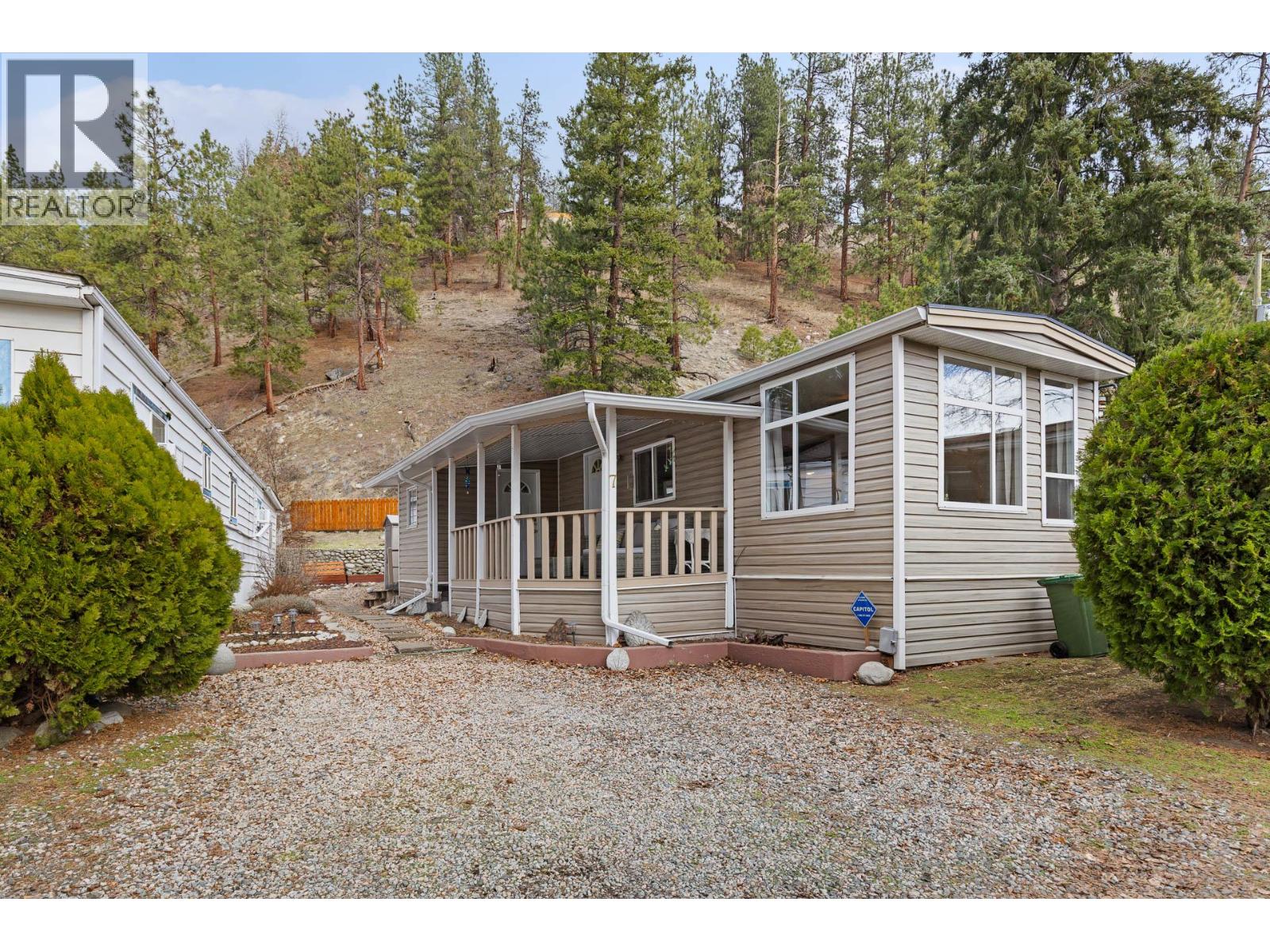 Welcome to a truly special opportunity in the heart of Peachland—recently nominated as Canada’s Kindest Community by Coca-Cola. This charming 1 bedroom, 1 bathroom single-wide mobile home (709 sq ft) is all about lifestyle, location, and serenity. Step inside and you’ll immediately notice the abundance of windows, filling the home with natural light and highlighting its cozy, welcoming character. Outside, the magic continues with a large covered deck overlooking Trepanier Creek—the perfect spot to enjoy your morning coffee, listen to the flowing water, or unwind at the end of the day. Tucked away at the bottom of the mountain on a quiet no-thru road, this home offers an incredibly private and peaceful setting, yet you’re just steps from the Peachland Mall, complete with shops, services, transit, and everyday amenities. From here, it’s an easy walk to Okanagan Lake, the pickleball courts, and all that vibrant Peachland has to offer. Located in a well-maintained 55+ community, this property is ideal for those looking to simplify without sacrificing convenience. One small pet is allowed, and you’ll appreciate the bonus of two parking spaces. This is more than a home—it’s a lifestyle surrounded by nature, community, and walkable amenities. The setting is absolutely serene and truly must be seen to be appreciated. Homes like this, in locations like this, don’t come along often. (id:48254)