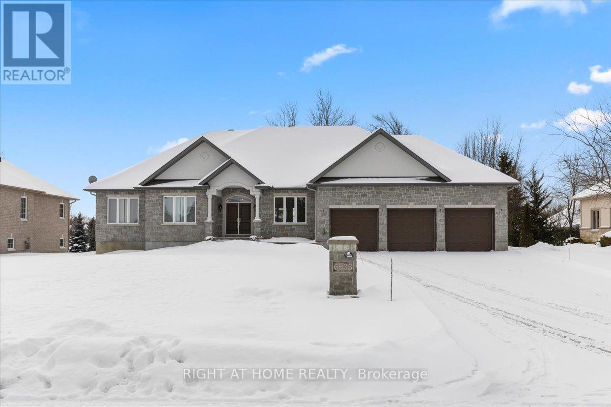 Absolutely gorgeous freshly painted 4-bedroom home on a beautifully landscaped 1/2-acre lot. The main floor offers a bright open concept floor plan with a kitchen featuring a beautiful, oversized island, as well as a living/dining area, perfect for family gatherings. Hardwood floors, vaulted ceiling and floor-to-ceiling stone fireplace. The other side of the main level consists of 3 good sized bedrooms plus an office room. Master Suite includes an en-suite bath with soaker tub, walk-in shower and double sinks. Many windows offer a peaceful view of the backyard. Double patio doors from the eating area leading to the large deck among the trees. The large basement is designed to entertain, included are bar taps, and dishwasher at the bar. You'll love the custom-built 16' bar, playground, fireplace and 9' ceilings, including a practical 4th bedroom with a 3pc bathroom. A 3-car garage is also always a plus. (id:48254)