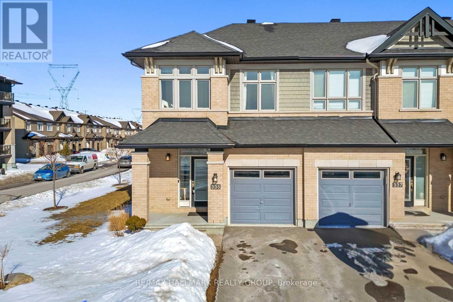 Welcome to 335 Livery St, beautifully designed end-unit townhome in Kanata. The largest Richcraft townhouse available, this Fairhaven model offers approx 2,500 sq ft of well-planned living space. Charming brick exterior, covered front porch, and added privacy of end unit create strong curb appeal. Step inside, bright foyer w/closet & powder room leads to open-concept main level. Hardwood floors, high ceilings & oversized windows create bright, airy feel. Modern white kitchen features quartz counters, SS appliances, designer finishes, ample cabinetry, and extended island w/ seating for 6, ideal for daily living & entertaining. The dining area & living room connect seamlessly, creating a comfortable space for everyday living or entertaining. At the heart of it all, the gas fireplace adds warmth & character, while the walkout leads directly to your private backyard. Outdoor space features interlock patio, gas BBQ hookup, raised garden beds, and storage shed, offering functional, low-maintenance outdoor enjoyment. Upstairs, spacious primary bedroom includes walk-in closet & private ensuite w/ glass walk-in shower, separate soaker tub, quartz counters. 2 additional bedrooms & versatile loft (offers potential  to be converted into a 4th bedrm) provide flexible space for family, guests, or home office. Full bath & laundry complete level. Finished basement adds over 500 sq ft of additional living space, ideal for recreation rm, gym, or play space, plus extra storage. Energy Star certified & thoughtfully designed, this home offers an open layout, abundant natural light, and exceptional use of space throughout. Attached garage & private driveway parking for 2 vehicles adds convenience. Located in the heart of Kanata, you're surrounded by everyday conveniences including Costco, Canadian Tire, COBS Bread, grocery stores, famous restaurants, and more. You're also close to great schools, the Trans Canada Trail & transit, making daily commutes & outdoor living equally convenient. (id:48254)