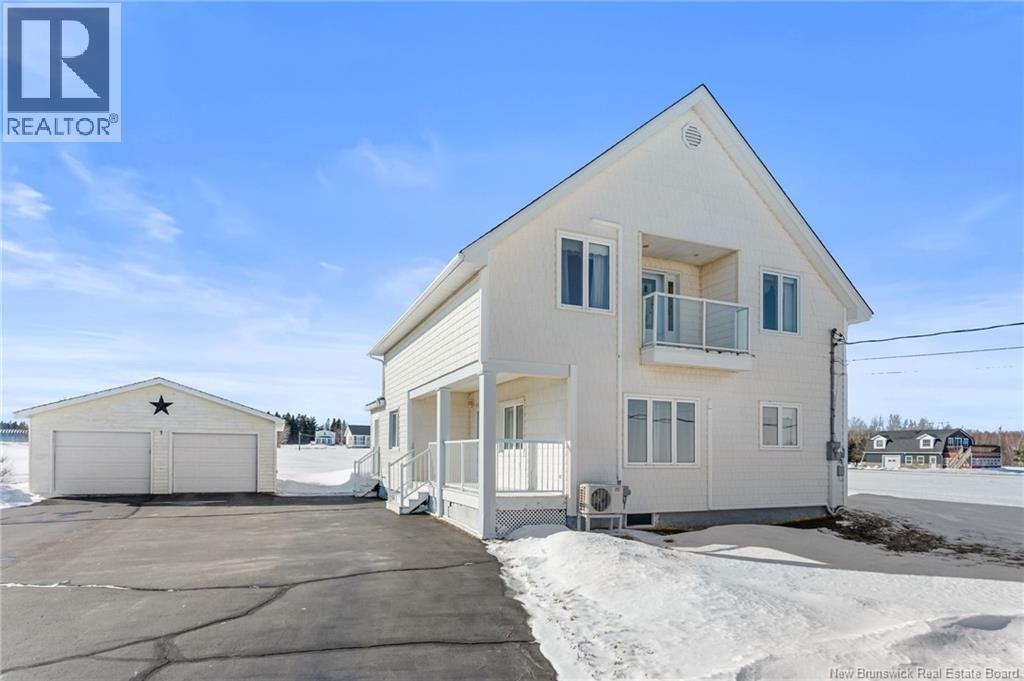 WELCOME TO 2123 ROUTE 530 in Grande-Digue, a charming Cape Cod inspired 1¾ storey home with stunning OCEAN VIEWS offering the perfect blend of character and seaside living. Originally built nearly 100 years ago, the home has seen significant updates, including a fully rebuilt second level (approx. 20 years ago), along with the roof, siding, and porch, giving it a much newer feel. Enter from the covered side porch into the inviting kitchen and dining area, fully renovated approximately 15 years ago and featuring a large island with bar seating, stainless steel appliances, and a cozy dining nook. The kitchen opens to a bright living room with large ocean-facing windows and a mini-split for year-round comfort with a view! Just off the kitchen, the winterized sunroom provides the perfect spot to relax while enjoying your morning coffee. A renovated 4-piece bath with laundry and a spacious bedroom complete the main floor. Hardwood floors run through the living room, bedroom, and hallway, complemented by updated vinyl flooring throughout the remaining areas. Upstairs, youll find two additional bedrooms, a 3-piece bath, and a lovely sitting room with a skylight, mini-split, and balcony access overlooking the serene ocean coastline! Set on a 2-acre lot with a detached double garage and just a 5 minute walk to the beautiful sandy beaches, this property would make the perfect home, summer cottage, or Airbnb! Book your private viewing today! (id:48254)