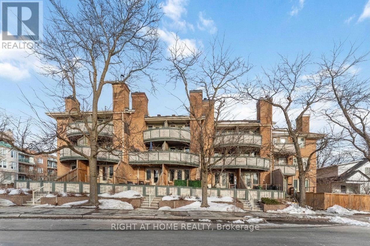 Beautifully maintained 2-bedroom, 2-bathroom terrace condo with a stunning west-facing balcony overlooking parkland. Ideally located across from NCC greenspace and the Rideau River, this bright and inviting home is perfect for those seeking a balance of urban living and outdoor lifestyle. Set in a quiet low-rise building in the welcoming community of Overbrook, this sun-filled condo features underground parking and reasonable condo fees, just steps from the Rideau Sports Centre and the pedestrian bridge to downtown-perfect for professionals who enjoy walking or biking to work. The open-concept main living area features beautiful floors, a fireplace, and large windows leading to a private balcony overlooking the park. The renovated kitchen includes timeless cabinetry, granite countertops, ceramic backsplash, plus a convenient pantry and main-floor powder room. Upstairs offers a spacious primary bedroom with 2 closets, a versatile second bedroom, and an updated bathroom. Includes in-unit laundry, central A/C, underground parking, and storage locker. Enjoy incredible access to Riverain Park, bike paths, tennis courts, and the Rideau Winter Trail right at your doorstep. (id:48254)