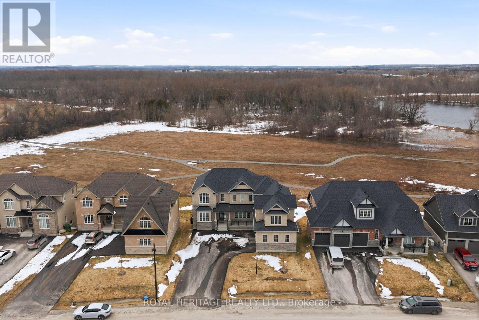 A rare riverfront lifestyle opportunity in Peterborough. Set along the scenic Otonabee River and surrounded by walking trails, 36 Golden Meadows Drive is an exceptional estate home offering refined design, thoughtful architecture, and over $200,000 in luxury upgrades. An impressive faade and triple-car garage set the tone, while inside 10-ft ceilings, engineered hardwood floors, and expansive windows create a bright and sophisticated atmosphere. The main level features a private office, formal living and dining spaces, and a spectacular open-concept layout designed for entertaining. The chef-inspired kitchen is appointed with top-of-the-line Thermador appliances, including an integrated refrigerator and professional-grade oven with convection and air fryer capabilities. A large centre island anchors the space, while the adjoining breakfast area walks out to a deck overlooking the river and trails. The family room offers a warm gathering space with a sleek wall-mounted electric fireplace and large picture windows with remote-controlled zebra blinds. The upper level is thoughtfully designed with two separate wings for privacy and flexibility. One wing features four spacious bedrooms, including the luxurious primary suite with double-door entry and a spa-inspired 5-piece ensuite with soaker tub, glass shower, and double vanity. The separate loft retreat above the garage, with its own entrance, hardwood floors, bright windows, and a 5-piece bathroom, offers incredible versatility. Ideal as a games room, family lounge, guest suite, or potential in-law space, this private wing adds a unique and highly desirable living option. Combining elegance, space, and breathtaking natural surroundings, 36 Golden Meadows Drive is a rare opportunity to own a luxury riverfront home in Peterborough. (id:48254)