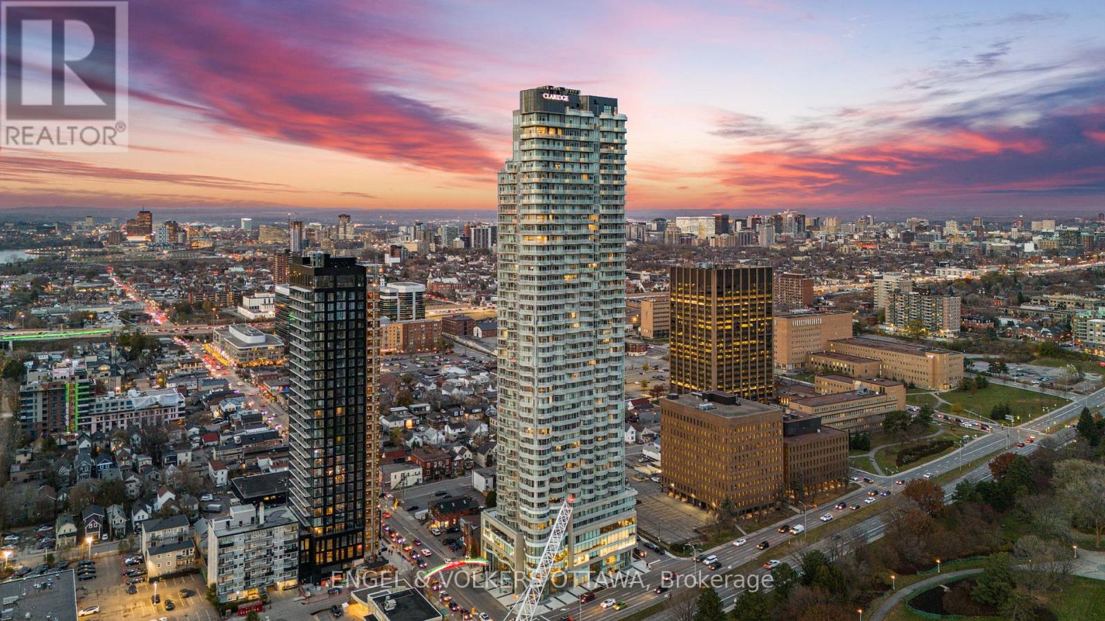 A SKY RESIDENCE ABOVE IT ALL. Perched high above Little Italy in The Icon, this beautiful 1,160 sq.ft. 2-bedroom, 2-bath condo captures breathtaking panoramic views from the Gatineau Hills across Dow's Lake and beyond, with spectacular light from sunrise to sunset. 3 private balconies extend from the principal rooms, creating a sense of openness. Recently reimagined with exquisite porcelain flooring, the interior feels sophisticated and entirely bespoke. A dramatic marble-inspired feature wall anchors the living space, paired with a sleek contemporary fireplace that introduces warmth and striking visual impact. Two imported statement chandeliers bring sculptural elegance and unmistakable glamour. Brushed gold detailing is integrated throughout the main living areas, from custom baseboard trim to upgraded faucets, hardware and kitchen sink, creating an elevated aesthetic. The kitchen is sleek with quartz surfaces and stainless-steel appliances. The primary suite offers a serene retreat with a beautifully designed walk-in closet and an elegant ensuite featuring a glass shower. A well-proportioned second bedroom provides flexibility for guests or a sophisticated home office. A beautifully appointed main 4-piece bathroom completes the home, finished with refined materials and a clean, timeless aesthetic. Electronic sun and heat screens and blackout blinds offer comfort and privacy at the touch of a button. In-unit laundry adds everyday convenience. Included is one of the building's most desirable three-sided parking spaces with two storage units. Life at The Icon places you moments from Dow's Lake, the Rideau Canal, and the restaurants of Little Italy. With a pool, sauna, gym, theatre, and guest suites. The Icon delivers an amenity-rich lifestyle with the feel of an urban resort. An exceptional opportunity to own a meticulously upgraded residence in one of Ottawa's most dynamic neighbourhoods. This is elevated living: Architectural. Intentional. Unforgettable. (id:48254)