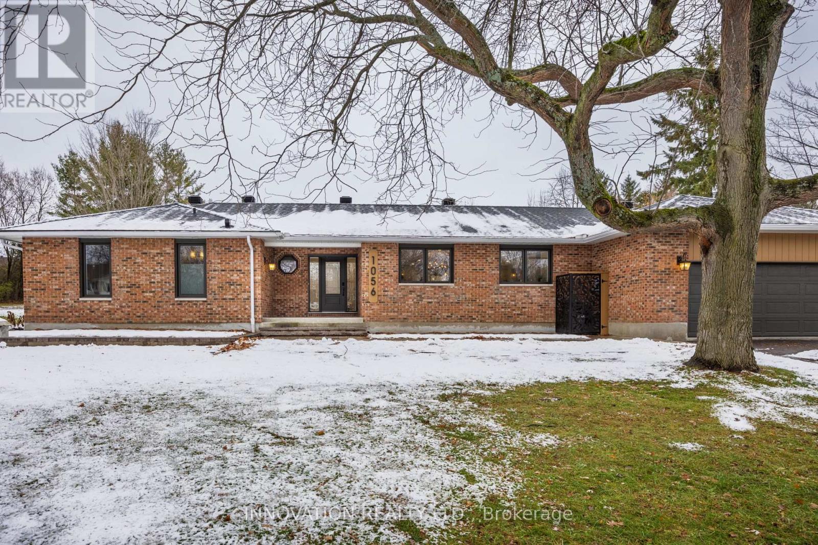 Welcome to 1056 Heenan Terrace, a spectacular custom-renovated multi-generational home set on over half an acre on the coveted South Island of historic Manotick. Surrounded by nature, water, and one of Ottawa's most desirable communities, this exceptional property offers the perfect blend of luxury, comfort, and convenience .At the heart of the home is a stunning gourmet kitchen designed to impress, featuring custom cabinetry, quartz counters, and exceptional appliances including Fulgor Milano built-in wall ovens, a 6-burner gas range, dishwasher, side-by-side fridge/freezer, custom hood fan, and a spacious walk-in pantry. Maple hardwood floors run throughout, while four gas fireplaces add warmth and elegance. The true showpiece, however, is the luxurious primary retreat. Designed as a private sanctuary, the spacious bedroom is enhanced by designer fixtures, and a peaceful atmosphere with stunning views of the rear yard. The spa-inspired ensuite is nothing short of extraordinary, featuring heated floors, a curbless shower, and custom cabinetry with quartz counters. Every element has been carefully selected to create a retreat that feels both luxurious and timeless.The additional bathrooms feature the same exceptional level of finish. Thoughtful touches are found throughout the home, including motion-sensor closet lighting, illuminated wall switches, central vacuum, and updated mechanical. Ideal for multi-generational living or an in-law suite, the fully renovated lower level is accessed by two separate staircases-one from the family room and another from the mudroom-allowing for exceptional privacy and flexibility. Filled with natural light, this level extra living space, den, 2 bedrooms, a full bathroom and kitchenette, making it perfect for extended family, older children, or guests.Outside, enjoy a new composite deck, interlock walkways, rough-ins for a future pool, and a 12' x 30' shed with hydro and overhead door. Luxury, lifestyle, and peace of mind await. (id:48254)