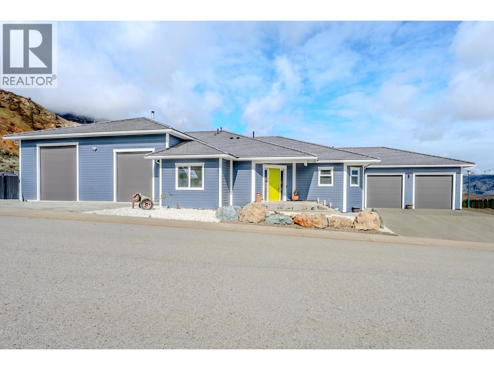 Custom-built with exceptional quality, this Augusta Lane home is perched on a 1/3 acre lot and offers over 5,500 sq.ft. of refined living—2,800 sq.ft. on the main and 2,700 sq.ft. below. Designed with unique styling and built to an uncompromising standard, this residence is priced well below replacement cost. Featuring an ICF foundation, Hardie siding, and concrete tile roof, with approx. 8 years of new home warranty remaining. Inside, 10-ft ceilings, 8-ft solid wood doors, and wide plank white oak flooring create a strong architectural presence. The chef’s kitchen delivers premium cabinetry, quartz counters and backsplash, a full butler’s pantry, Bosch appliances with double wall ovens, and a 5-element induction cooktop. The primary suite offers a custom walk-in closet with island and a spa-inspired ensuite with oversized tiled shower. Comfort and efficiency are elevated with natural gas on-demand hot water, standby generator, and full home water filtration, softener, and reverse osmosis. Outdoor living is anchored by a massive covered deck, gas BBQ hookups, hot tub, and pool-ready yard with underground irrigation. Parking and workspace are unmatched with an oversized double garage for full-size pickups plus a massive 2-bay approx. 1,300 sq.ft. commercial-grade shop with 16-ft ceilings, heating, A/C, and private bathroom. Complete with Hunter Douglas blinds, security, and holiday lighting. Just minutes to Osoyoos Golf Club and Osoyoos Lake. (id:48254)