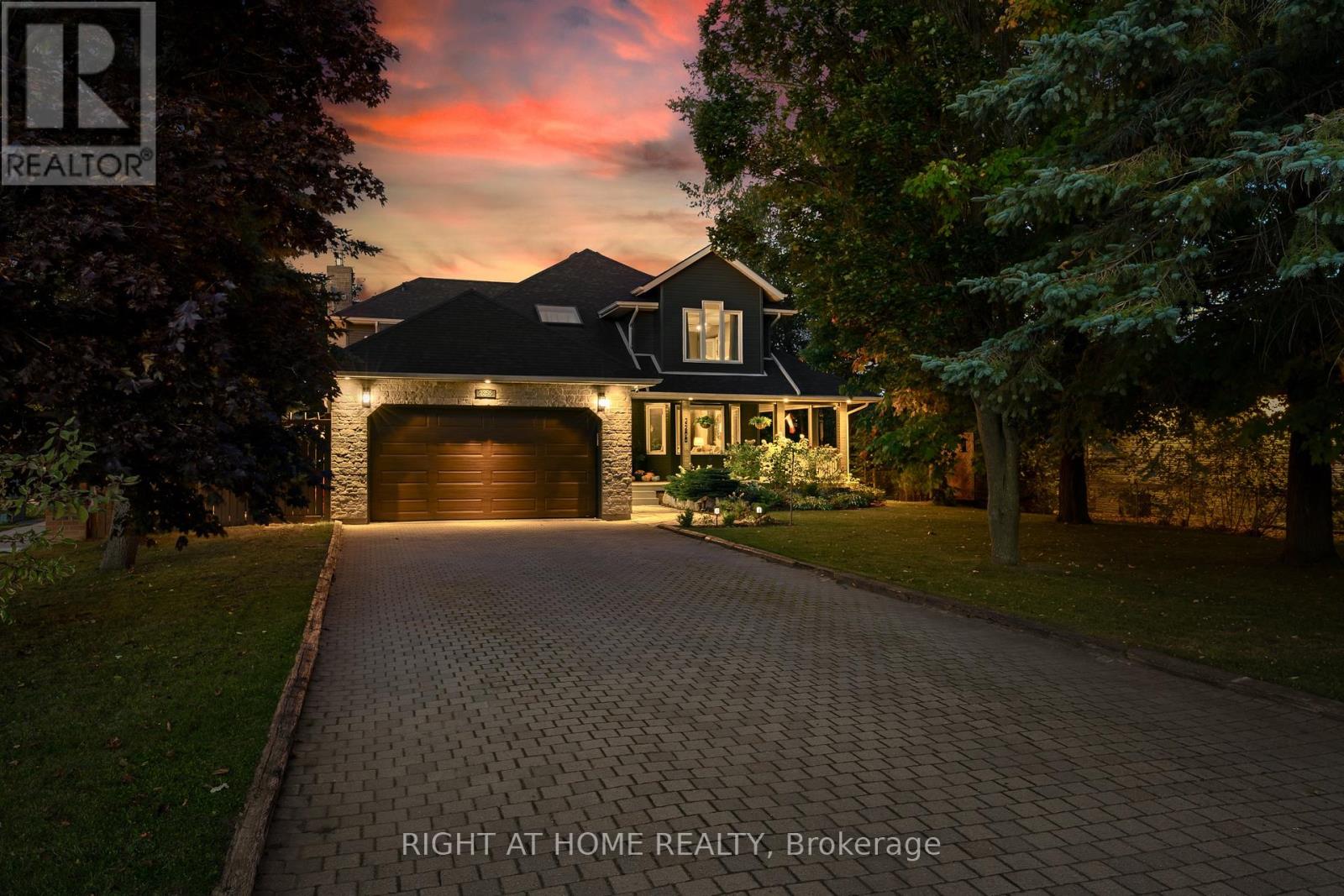 2 MINUTES TO LAKE SIMCOE. A LOT THAT ACTUALLY GIVES YOU SPACE. AND A HOME THAT JUST FEELS RIGHT. You don't come across properties like this very often. 67 x 201 ft corner lot, mature trees, and over 2,700 sq ft above grade... plus another 1,366 sq ft below. It's not trying to squeeze everything in; It just has the space. And you feel that right away. The wraparound porch sets the tone. It's the kind of feature you don't see often... and when you do, you realize how much you'd actually use it. Inside, the layout flows without feeling awkward. The kitchen is central and ties everything together. Quartz counters, a large island, pot lights, and open sightlines into the main living space. A formal dining room and an eat-in kitchen. Living room plus a separate family room with a gas fireplace... so you're not trying to make one space do everything. Easy access to the yard makes it simple to actually use and enjoy. Upstairs, the primary suite includes a walk-in closet and a 5-piece ensuite. Good-sized bedrooms, large closets, and an updated skylight and upper-level windows. The basement adds another 1,366 sq ft. Partially finished, so you can use it now and still have room to do more later. Inside entry to a heated double garage, plus a driveway with no sidewalk and plenty of parking.The backyard is set up with a newer deck, low-maintenance perennial gardens, and mature trees for privacy. Updates have been done over time, including the kitchen, bathrooms, some windows, roof, furnace, A/C, water heater, lighting, doors, and more. (id:48254)
