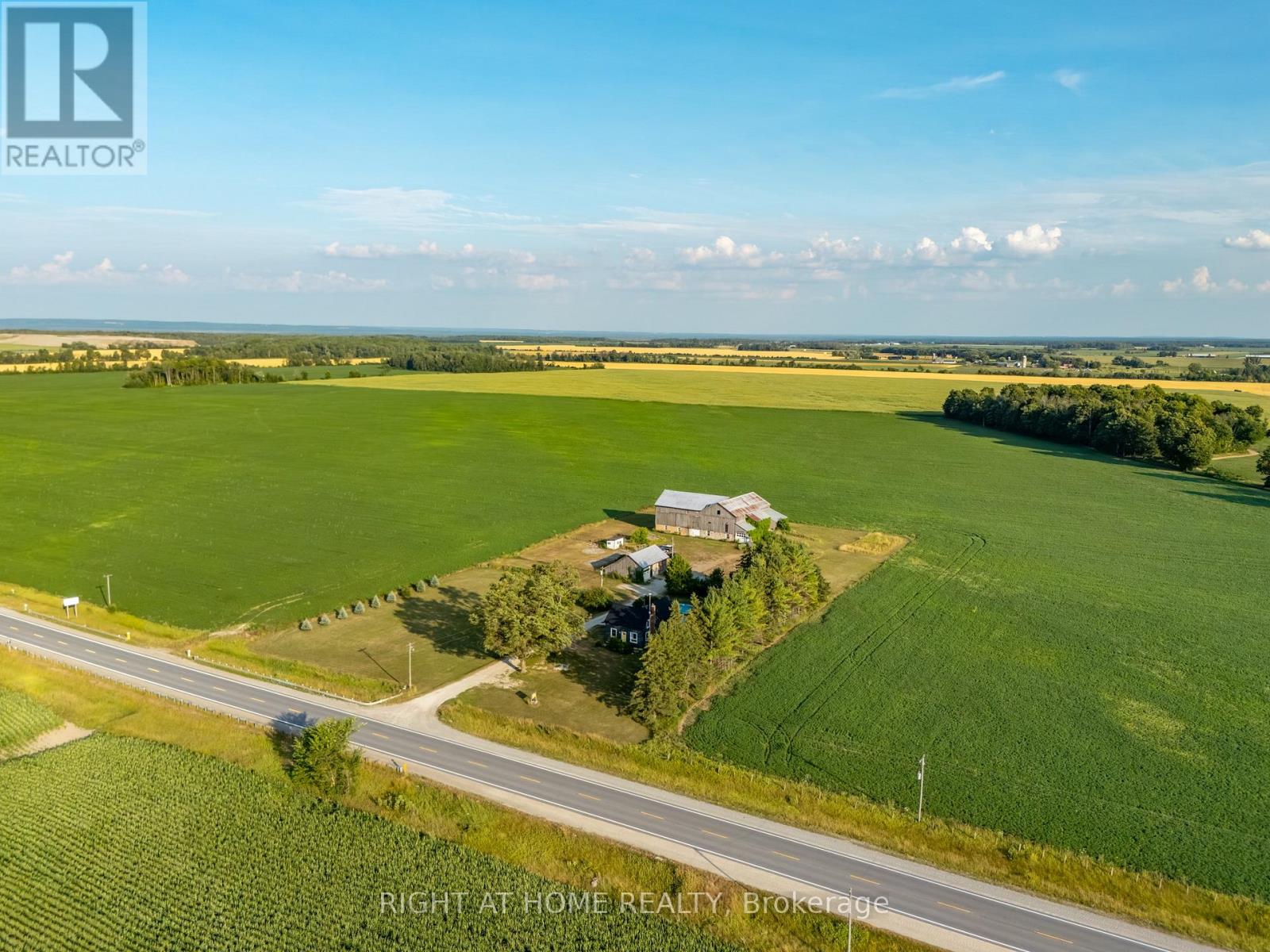 Welcome to your opportunity to live more intentionally on over 3 peaceful acres, just minutes from Wasaga Beach. This beautiful Century Home blends charm, space, and lifestyle flexibility, ideal for those dreaming of a hobby farm, home-based business, or simply more room to grow.The property features a large barn (approx. 67' x 36' x 86'), a 35' x 40' detached workshop/garage and multiple outbuildings, offering endless potential for future projects and personal goals. Inside, the home combines character with comfort, offering 4 bedrooms, 2 bathrooms, a welcoming foyer, and a cozy sitting room with a fireplace and brick accents. The updated  kitchen is both stylish and functional, while the oversized upstairs bedroom provides space for a home office, studio, or private retreat.Located minutes to schools, shops, and amenities, this property offers rural tranquility with urban convenience. (id:48254)
