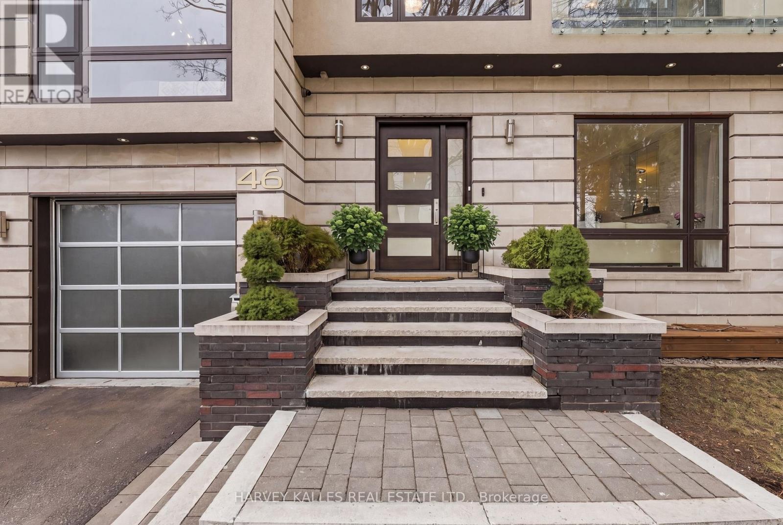Welcome to 46 Ravenscrest Drive! An exceptional, custom-built residence nestled on a rare & highly coveted ravine lot in the heart of Etobicoke. This stunning 4+1 bed, 5 bath home offers the perfect blend of modern design, luxury finishes & breathtaking natural surroundings. Flooded with natural light, the open-concept layout showcases clean architectural lines, a spectacular wall of windows & multiple skylights that create an airy, inviting atmosphere throughout. A double-sided built-in fish tank elegantly separates the family room & kitchen, adding a unique focal point to the living space. The chef-inspired kitchen features a large island, high-end appliances & a walk-out to a private balcony overlooking the serene ravine... perfect for morning coffee or evening relaxation. The main floor is finished with sleek porcelain tile, while the second and third levels feature rich hardwood flooring, complemented by custom lighting & pot lights throughout. The expansive primary retreat is a true sanctuary, offering uninterrupted ravine views, a spacious walk-in closet & a luxurious spa-like ensuite. Generously sized secondary bedrooms provide comfort & flexibility for growing families. Designed for everyday living & entertaining, the backyard is a private oasis featuring an in-ground pool, lush green space, stone interlock dining area & multiple outdoor lounging zones. Fully fenced with direct ravine access, this property offers unparalleled privacy & tranquility. The fully finished basement elevates the home even further with a state-of-the-art projection home theatre, custom sectional seating, a dedicated fitness area, a fifth bedroom with ensuite & abundant storage space. Complete with a private garage & ample driveway parking for up to four vehicles, this home checks every box. Located in a prestigious, family-friendly neighbourhood where ravine properties are rarely offered, this is a truly unique opportunity to own a one-of-a-kind home with spectacular views! (id:48254)