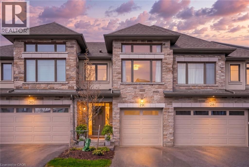 This is more than a townhouse - it's a thoughtfully crafted luxury residence offering 3 bedrooms, 4 bathrooms & nearly 2,500 SF of elegant living. Ideally situated on a peaceful, family-friendly street in the coveted Carriage Crossing. Step inside to a bright, open-concept main floor where soaring 9-ft ceilings and engineered hardwood flooring create a sense of space and sophistication. The heart of the home is the chef's kitchen, featuring Cambria quartz countertops, SS appliances including a gas stove with a double oven, wine fridge, cabinetry extending to the ceiling, under cabinet lighting & a spacious pantry. A convenient 2-piece bath and a main floor laundry/mudroom completes the main level. The private primary retreat occupies its own dedicated floor, with grand-sized windows, an oversized walk-in-closet and a stunning ensuite showcasing a glass shower & Cambria quartz countertops. Upstairs, the top level provides incredible flexibility with a spacious open office, along with two generous, sun-filled bedrooms. The main bathroom is thoughtfully designed with a separate water closet and a shower/tub combination - ideal for family living. The finished look-out basement extends your living space even further, featuring 9-ft ceilings, engineered hardwood flooring, a beautifully appointed 3-piece bathroom with a glass shower, Italian marble tile, and herringbone floors. The rec room is perfect for a games room, playroom, or even a fourth bedroom. Outdoors, unwind on your back deck and enjoy the sounds of birdsong, visits from hummingbirds, and scenic walks along nearby trails where deer sightings and gorgeous sunsets are part of everyday life. Perfectly positioned minutes from top-rated schools, Grey Silo Golf Club, RIM Park, Universities, tech campuses, St. Jacobs, and major highways. A truly turnkey lifestyle - where exterior maintenance, from summer landscaping to winter snow removal, is professionally managed. This home truly offers the best of both worlds. (id:48254)