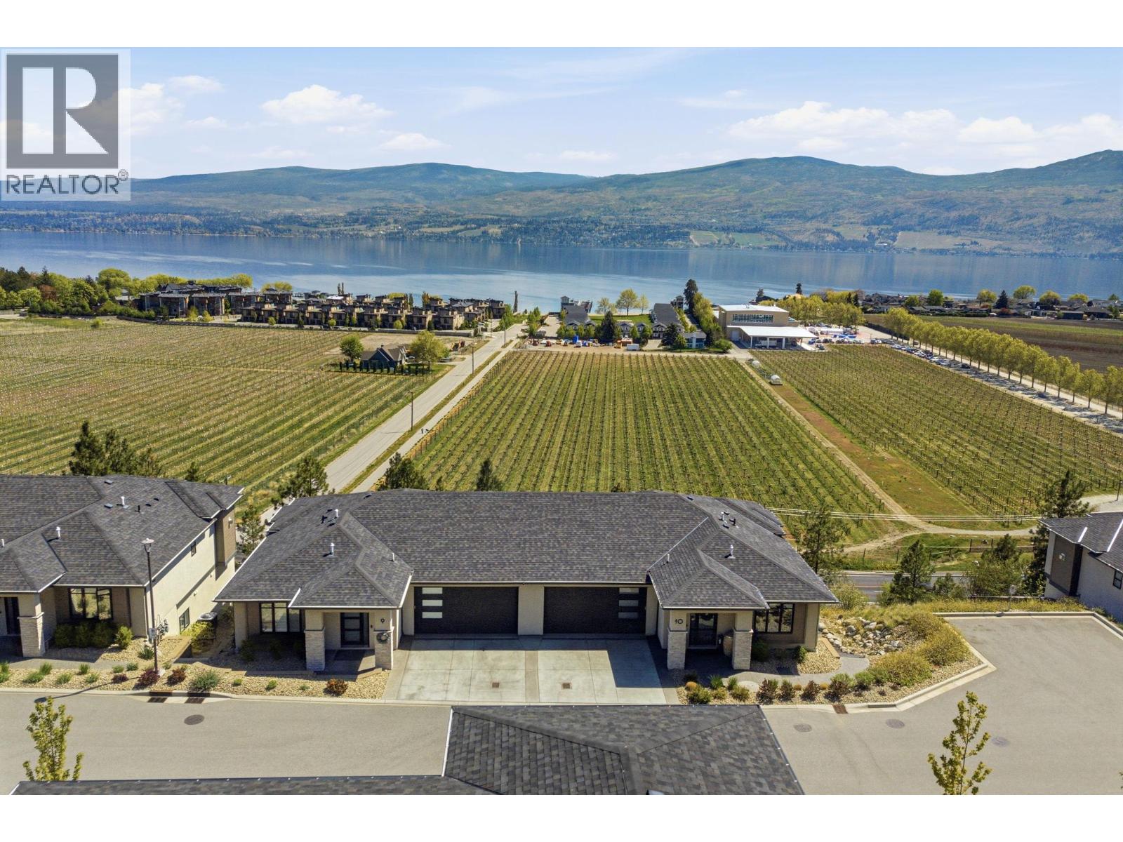 If you've worked hard for the lake view you've always wanted this is the one to see. This is an end-unit walkout rancher with walkout basement overlooking a working vineyard, with a protected lake view that can't be built out. The easement below the property guarantees it.  This quality build is backed by Dilworth Homes reputation & meticulously maintained ever since. With just over 2,000 sq ft finished, 3 beds & 3 baths & the primary on the main — this is the preferred floor plan semi-retired & retired buyers keep asking for. Open-concept kitchen with quartz counters, gas range, soft-close drawers & full pull-outs throughout plus the dining and living room all capture natural light. The covered deck has a natural gas BBQ hookup, electric sunshade and stellar views. Two-car garage with epoxy floor, built-in cabinetry & overhead storage. Lock & leave & you're ready to go. Sunrise Pointe is a small, niche strata complex of 18 — Lakeview Heights inventory like this rarely comes up - executive style turnkey living.  Live walking distance to the wineries & Pritchard Beach with only a short drive to vibrant downtown Kelowna. You're buying the view, the build, & a floor plan that works for the next twenty years — not just the next five. (id:48254)