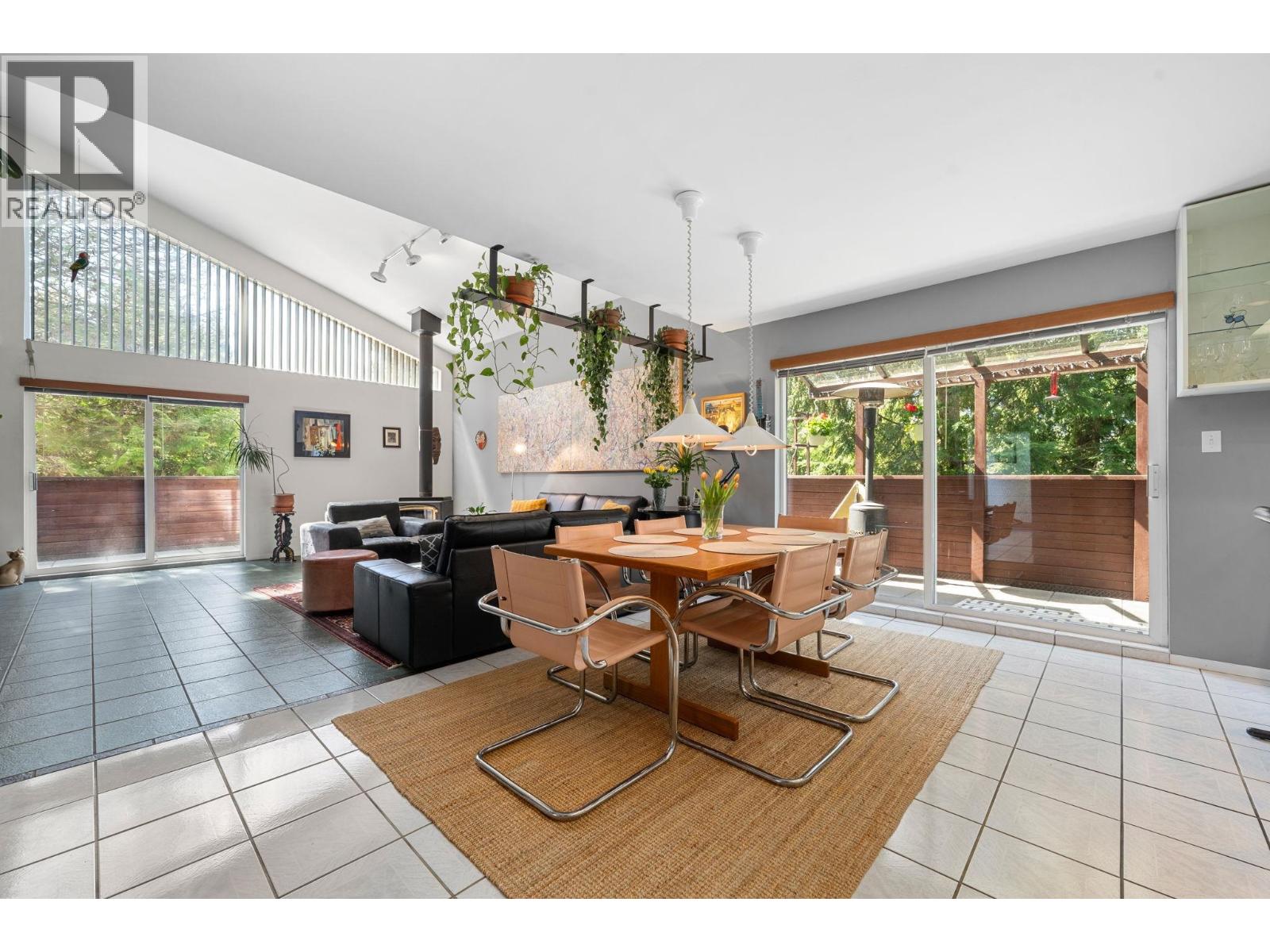 Unique custom-designed beautiful home with vaulted ceiling and post-and-beam wood accent. A wide, grand staircase leads you to the upper level, enhancing the home's impressive design. Bright, airy open-concept main living space with upper loft that's perfect for a home office. Enjoy a wraparound balcony with private, serene mountain views, set at the end of a quiet cul-de-sac surrounded by nature. Both bedrooms feature their own ensuite, with 4 bathrooms in total. Radiant heated tile flooring on the main & lower level adds comfort year-round. Lower level offers a large recreation room + hobby room with potential for two additional bedrooms or a suite. Bonus is a 3-car garage, including an over-height bay ideal for an RV, boat, or hoist. Incredible potential! Viewings by appointment only. (id:48254)