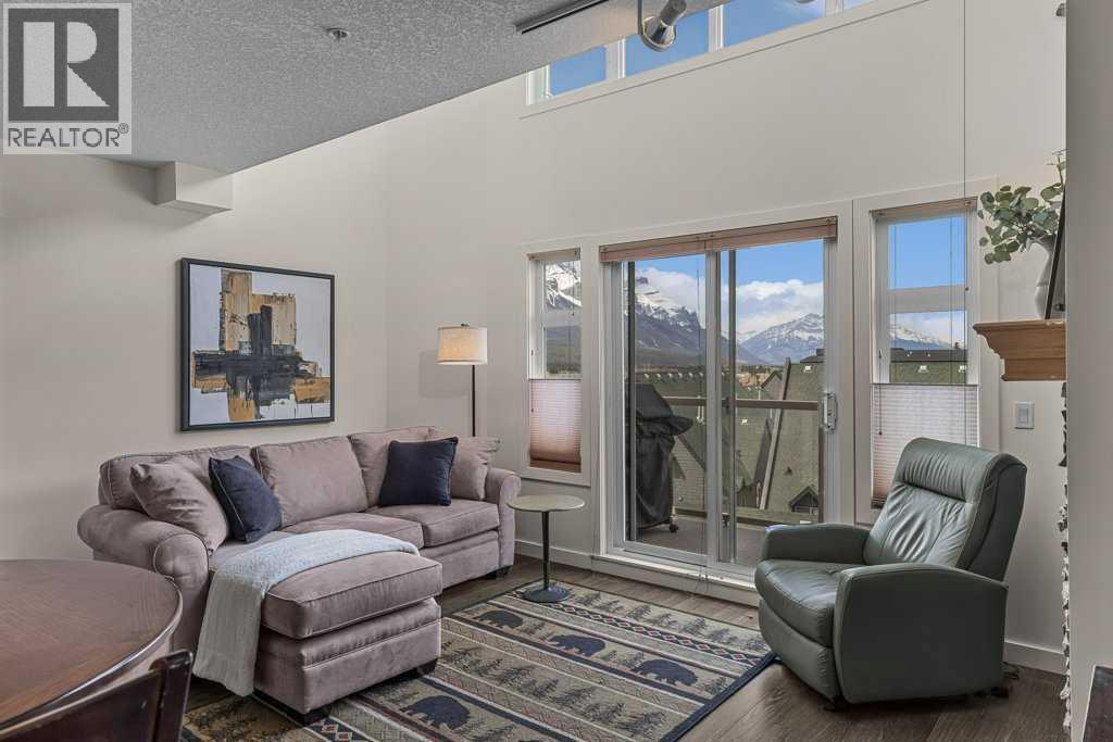 Amazing 180 degree NW views that showcase every mountain in the northern half of the Bow Valley including the whole of the Rundle Range, Fairholm Range with Cascade mountain beside Banff clearly visible in the distance. Enjoy watching the sun set over Mt. Rundle from your NW facing patio or from the window over the kitchen sink. The 2 floor layout is popular for guests with great separation between the upper and lower levels and often gets more revenue than a single level unit. The property has many upgrades including appliances and new counter top in the kitchen. You will enjoy relaxing in front of the fireplace after a day spent out. Heated underground parking and storage locker in the parkade makes for a warmer winter and gear storage. Owners can enjoy the indoor gym and either of the two outdoor hot tubs for good workouts and relaxation. The condo is an easy stroll from the heart of Canmore downtown and Spring Creek is just down the hill. The Tourist Home zoning means that the unit can be lived in full time, self-managed on Airbnb, or use a 3rd Party Airbnb manager for strong revenue! (id:48254)