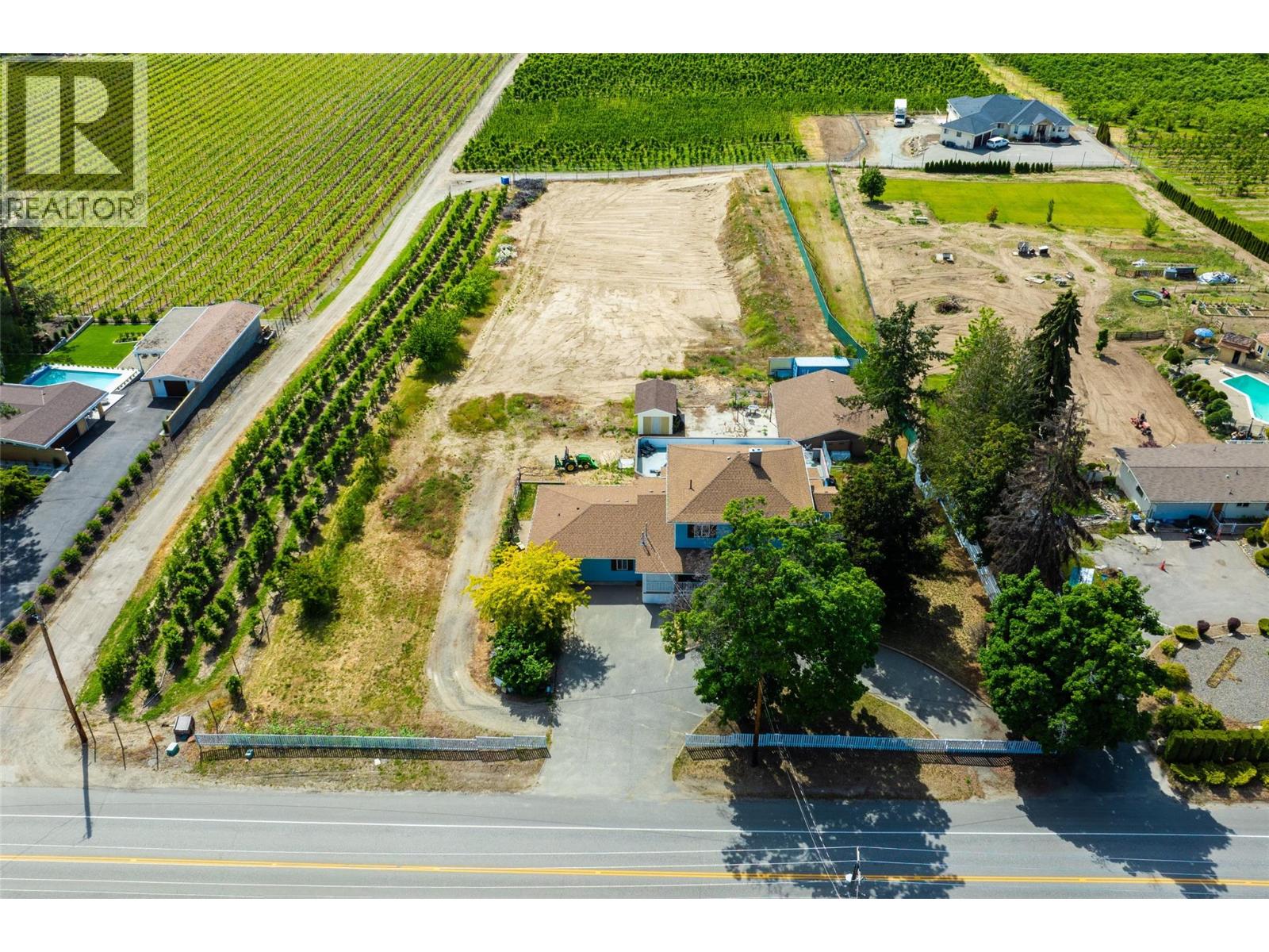 MOTIVATED SELLER! EXCELLENT INVESTMENT- HUGE RENTAL POTENTIAL AND MORE! Expansive and elegant home situated on 2.1 acres in distinguished area of South East Kelowna! THIS GREAT HOME boasts almost 5000 sq. ft, with many updates, improvements throughout! The main part of the home has 3 levels with 5 bedrooms + 5 bathrooms, ample Living Room, Dining and Kitchen areas. THIS HOME ALSO HAS A BEAUTIFULLY UPDATED, SIDE ATTACHED, GROUND LEVEL, 2 BEDROOM IN-LAW-SUITE, APPROX. 1,000 SQ. FEET, KITCHEN, LIVING ROOM, FULL BATHROOM AND MORE! BASEMENT HAS A SEPARATE ENTRANCE WHICH LEADS TO FAMILY ROOM, 1 BEDROOM, BAR KITCHEN POTENTIAL, FULL BATHROOM AND MORE! Detached SHOP has 1,200 SQ FT.  with 200 AMP service,  perfect for garage, workshop, indoor growing, sorting of fruits, vegetables, micro-greens, which was a previous use.  Acreage is RR1 zoning and not in ALR zoning and has positive potential and space for agricultural uses, rental income streams, estate property and even minor veterinary uses and more! Large swimming pool-patio area that could be brought back to operating condition by new owners if desired. Situated only minutes away from Central Kelowna attractions, amenities, golf courses, recreation, this home and acreage is perfectly situated among estate and agricultural properties. Measurements and square footage are approximate, please view measurements, sq. footage with included floor plans. Bring your ideas to make this property your forever home and more! (id:48254)