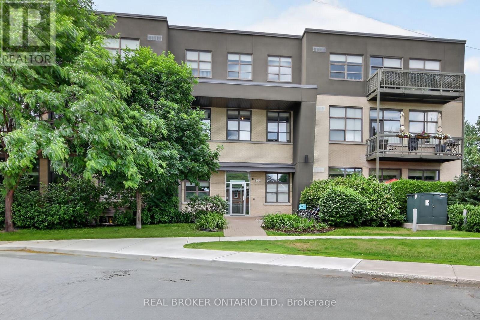 Welcome to this truly unique living space in a LEED-certified School Conversion (approx 2008)! This modern, spacious 1 bedroom + den condo offers approximately  935 sq ft (per builder plan) of thoughtfully designed, open-concept living. Enjoy gorgeous sunsets off your balcony. The kitchen includes stainless steel appliances, granite island and lots of cupboard space. Over-sized windows w/ privacy shades let in so much natural light. The 11' ceilings make it feel like a loft! The bedroom has side-by-side closets. In suite laundry. Large den with glass-paneled door is a perfect work from home office space. 1 outdoor parking space & storage locker are included. Harwood floor in the main areas. Painted 2026. Carpets cleaned 2026.  Smoke-free building. A great condo in a one-of-a-kind building is ready for its new owner! Parking spot #18, Locker #6 (id:48254)