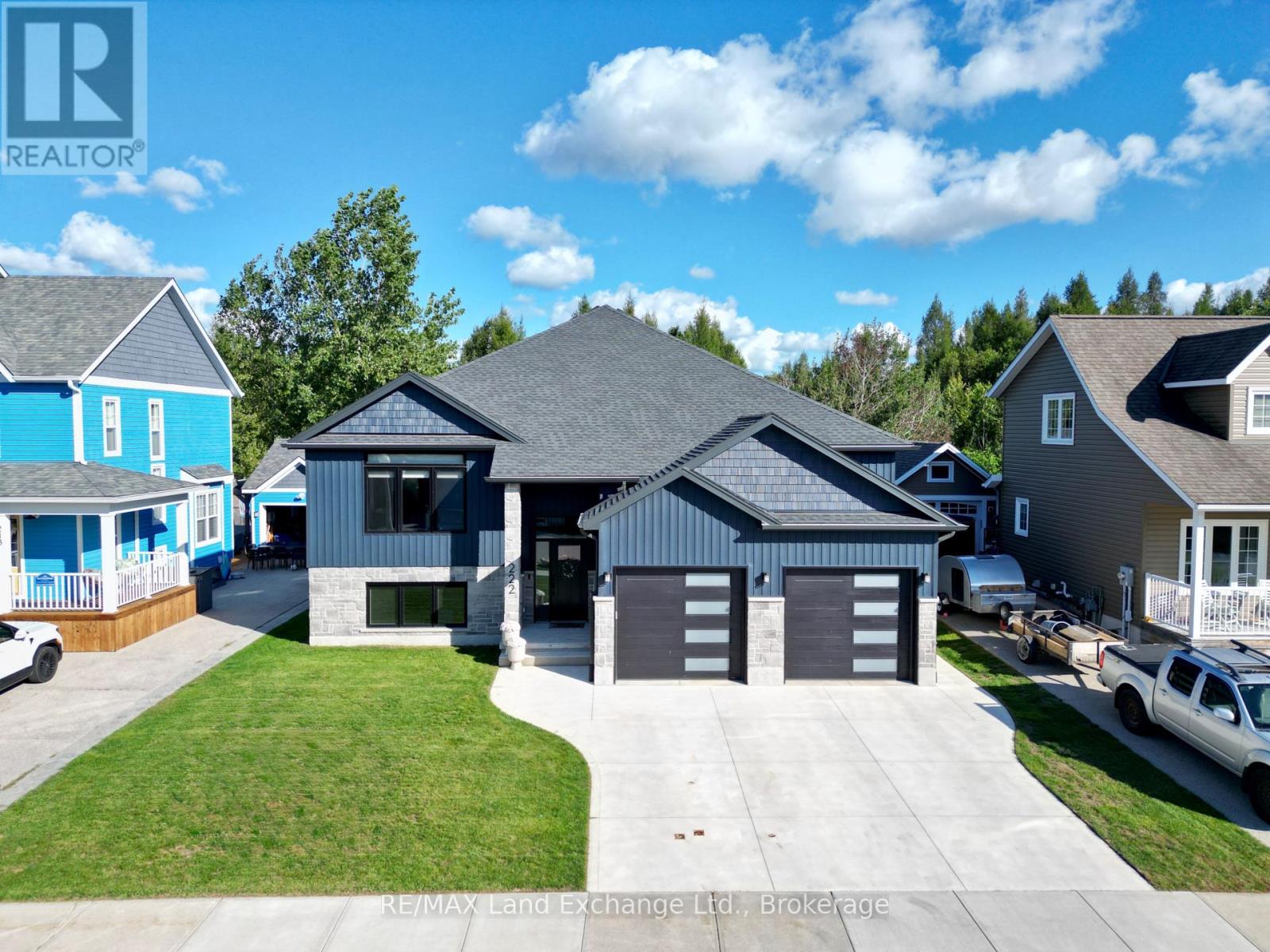 Welcome to 222 Emerald Dr. Located just a short stroll from the beach and downtown High Street, this immaculate 1,625 sq. ft. raised bungalow offers luxury coastal living with incredible income potential. Step into a breathtaking open-concept kitchen, dining, and living area, perfectly accented by an elegant tray ceiling. The kitchen is an entertainer's dream, featuring a spacious walk-in pantry, premium quartz counters throughout, and an oversized sliding door that flows seamlessly out to a beautiful covered backyard deck.  The main residence offers 2 bedrooms and 2 baths, plus a bonus lower-level flex space. The primary bedroom boasts a spa-inspired ensuite with in-floor heating and Safe'n'Sound insulation for ultimate peace and quiet. The fully legal, separate-entrance basement apartment is a standout feature. With soaring 9-foot ceilings, a full second kitchen, 2 bedrooms, and 1 bath, it is perfectly designed for multi-generational living or offsetting your mortgage as a turn-key investment.  A rare opportunity to own a meticulously crafted home just minutes from world-class Lake Huron sunsets. (id:48254)