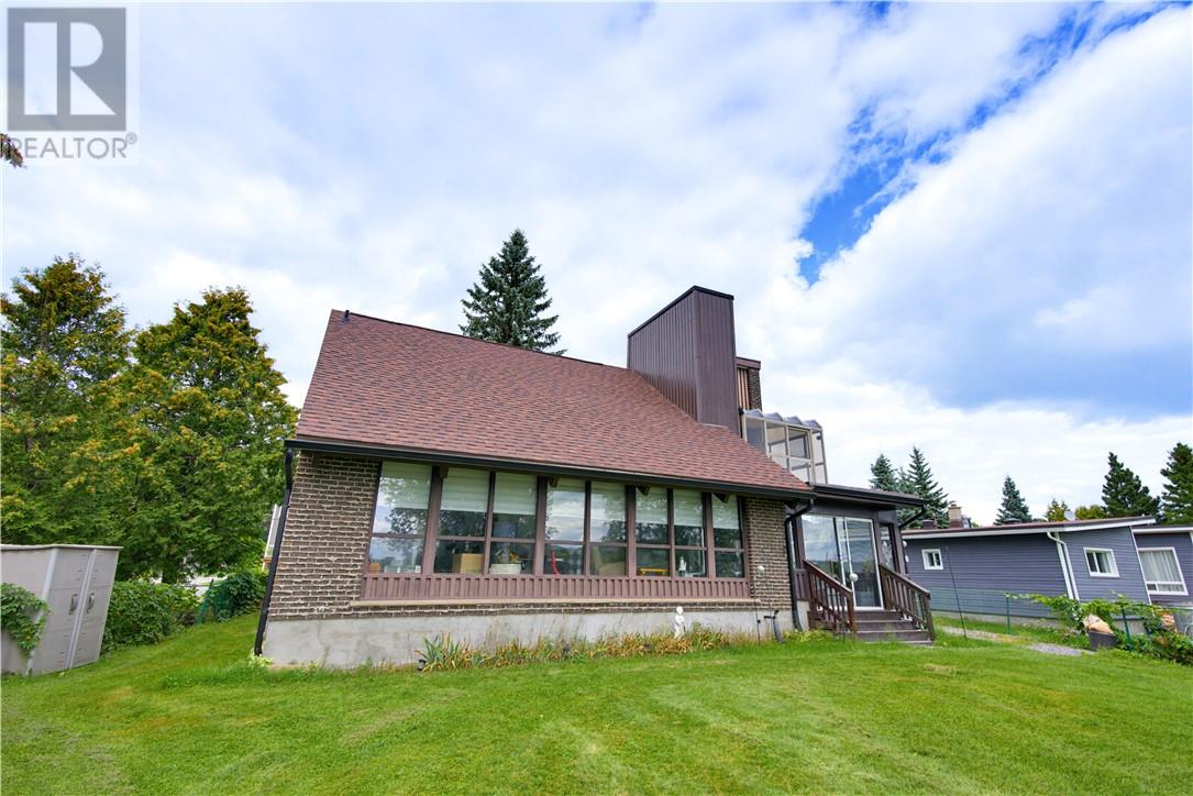 SOLID BRICK. SERENE WATERFRONT. Imagine starting your morning with the quiet of Richard Lake just outside your door, enjoying coffee in the gorgeous sun room as the day begins, spending summer afternoons by the water and ending the evening watching the light settle across the lake. Set on the shores of Richard Lake, 2389 Desloges Road is a solid all-brick home offering 3 bedrooms, 1 full bathroom and 2 half bathrooms, surrounded by the kind of natural setting that makes Northern Ontario living so special. Inside, the home offers a comfortable layout with spaces designed for gathering, relaxing and enjoying every season. A gas fireplace adds warmth and character to the main living space, creating an inviting place to unwind after a day on the lake. The beautiful sunroom is sure to become a favourite spot, offering a peaceful connection to the outdoors and the ever-changing views beyond. The lower level brings even more personality and versatility, featuring a wood stove for cozy evenings and a summer kitchen that opens the door to all kinds of possibilities, from entertaining family and friends to creating your own comfortable retreat for lake-season living. Outside is where this property truly comes alive. The waterfront setting provides a peaceful backdrop for everyday living, summer gatherings and four-season enjoyment. Whether you're looking for a place to settle in and enjoy year-round or a property where weekends naturally slow down, this is a home that invites you to appreciate the lake, the land and the lifestyle. There's something timeless about a solid brick home on the water. Add in the sun room, fireplaces, summer kitchen and beautiful Richard Lake setting, and you have a property with a warmth and character all its own. Opportunities like this don't come along every day. Come experience 2389 Desloges Road for yourself. (id:48254)