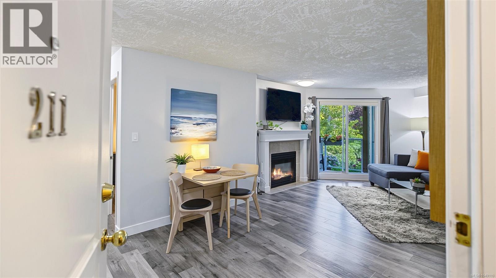 #211 offers a large open floor plan with a DEN. The patio doors look towards the courtyard and the landscaping offers privacy in the unit.