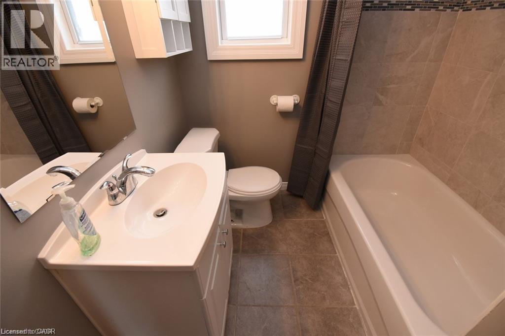 White vanity with integrated sink, chrome faucet, and storage cabinet