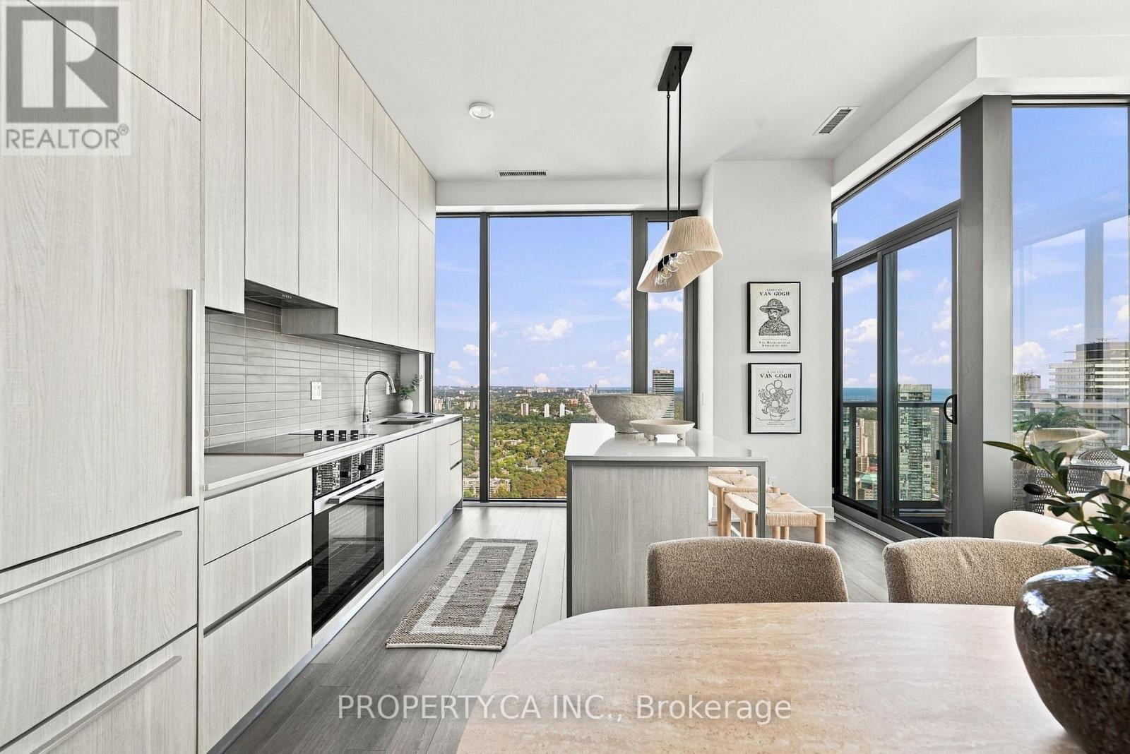 Welcome to 8 Cumberland, a prestigious Yorkville address where luxury, sophistication and breathtaking views come together. Pristine, never before lived in, penthouse, this spectacular 51st-floor corner property offers 1,280 square feet of beautifully designed open-concept living, soaring 11-foot ceilings and extraordinary, uninterrupted Southeast panoramic views. From virtually every room, enjoy an ever-changing backdrop from sunrise to sunset, stretching from the treetops of Rosedale to the downtown skyline and Lake Ontario, as far as the eye can see. The chef-inspired kitchen features a full suite of premium Miele appliances and flows seamlessly into the living and dining areas, creating an inviting space for both everyday living and entertaining. The thoughtfully designed layout features two spacious bedrooms, both with walk-in closets, including a luxurious primary retreat, two beautifully appointed bathrooms, and a stunning den/office that could easily be converted into a third bedroom. Step outside to your private balcony and take in the sweeping views high above the city. The location is exceptional. At the corner of Cumberland and Yonge, you are steps from the very best of Yorkville, including world-class shopping, exceptional dining, Whole Foods, galleries, cafés and entertainment. Nearby Summerhill, Rosedale and the Don Valley Parkway provide effortless access to everything Toronto has to offer.Complete with one extra-large parking space and two lockers, this is a rare opportunity to experience elevated penthouse living in one of Toronto's most coveted neighbourhoods. Come for the views. Stay for the lifestyle. You may never want to leave (id:48254)