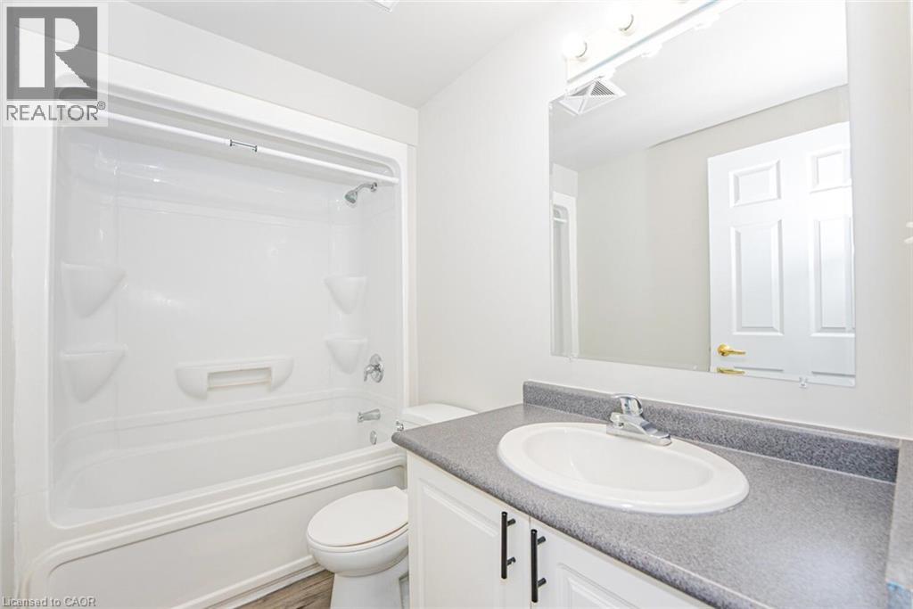 White tub and shower combination with chrome fixtures