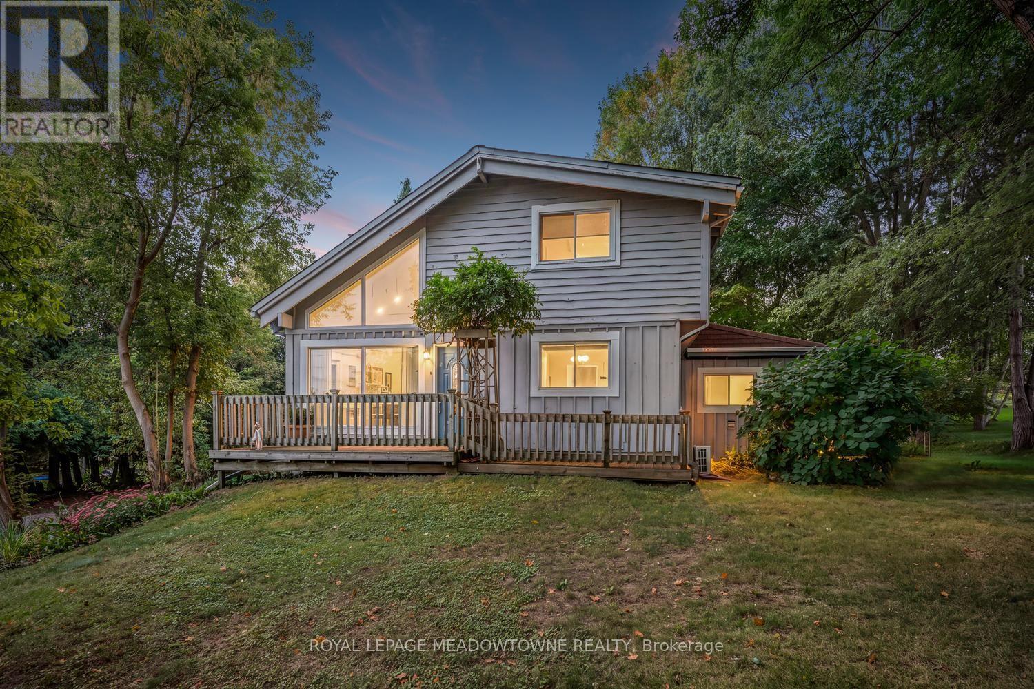 Nestled on one of Alton's most picturesque and sought-after streets, this charming home offers the perfect blend of village charm, natural beauty, and modern convenience. Surrounded by Caledon's rolling hills and set on a private backyard oasis, you'll enjoy peaceful living just steps from scenic hiking trails, meandering streams, and breathtaking countryside. Experience the best of Alton's vibrant community with the renowned Millcroft Inn, Alton Mill Arts Centre, Ray's 3rdGeneration Bakery, and the Toronto Osprey Valley golf courses all just a short stroll away. Whether you're enjoying a morning coffee, exploring local galleries, or teeing off on championship fairways, this exceptional location offers an unmatched lifestyle. Inside, the home features a recently updated kitchen designed for both everyday living and entertaining. The finished lower level includes a separate entrance, second kitchen, and a cozy living area-ideal for extended family, guests, or potential in-law accommodations. Year-round comfort is ensured with four ductless heating and cooling systems, complemented by two natural gas radiator heating units and a gas fireplace for efficient and reliable warmth. Conveniently located near major commuter routes, this exceptional property offers the tranquility of country village living without sacrificing accessibility.A rare opportunity to own a beautifully maintained home in one of Caledon's most beloved communities. (id:48254)
