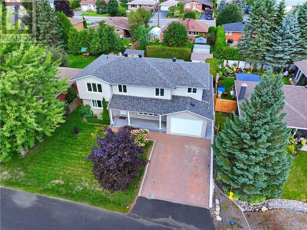THE SPACE YOU WANT. THE NEIGHBOURHOOD YOU LOVE. When you love where you live, sometimes the answer is to stay and build on what you already have. That’s exactly what the owners of this impressive South End home decided to do, renovating and building up to create a large 5-bedroom, 3.5-bathroom all-brick home with plenty of space for family and everyday living. Inside, bright bedrooms provide plenty of comfortable space, while the kitchen's dining area overlooks the beautifully landscaped backyard. The spacious primary bedroom features its own ensuite, and the lower level offers a spacious rec room with a fireplace, perfect for movie nights, games or simply winding down. Then there's the backyard, a two tiered deck, pool, hot tub and gazebo create an inviting space for summer days and evenings, with direct walk-in access to the pool from the deck. The sauna adds another way to unwind, making it easy to enjoy a little at-home pampering without going anywhere. It's the kind of setup that makes staying home feel pretty good. Interlocking stone runs through the driveway and backyard, while the attached garage features double doors with access from both the front and backyard, offering practical flexibility for storage, projects and outdoor activities. Set in a well-established South End neighbourhood, this is a home that offers impressive space, thoughtful improvements and a lifestyle that's easy to enjoy. A rare opportunity to stay in a neighbourhood you already love while having the space to live a whole lot bigger. (id:48254)
