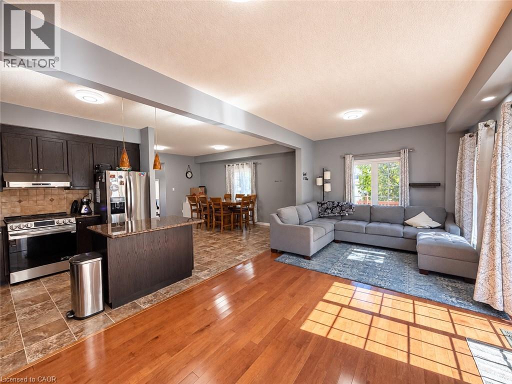 Open-concept living area with wood-finish flooring