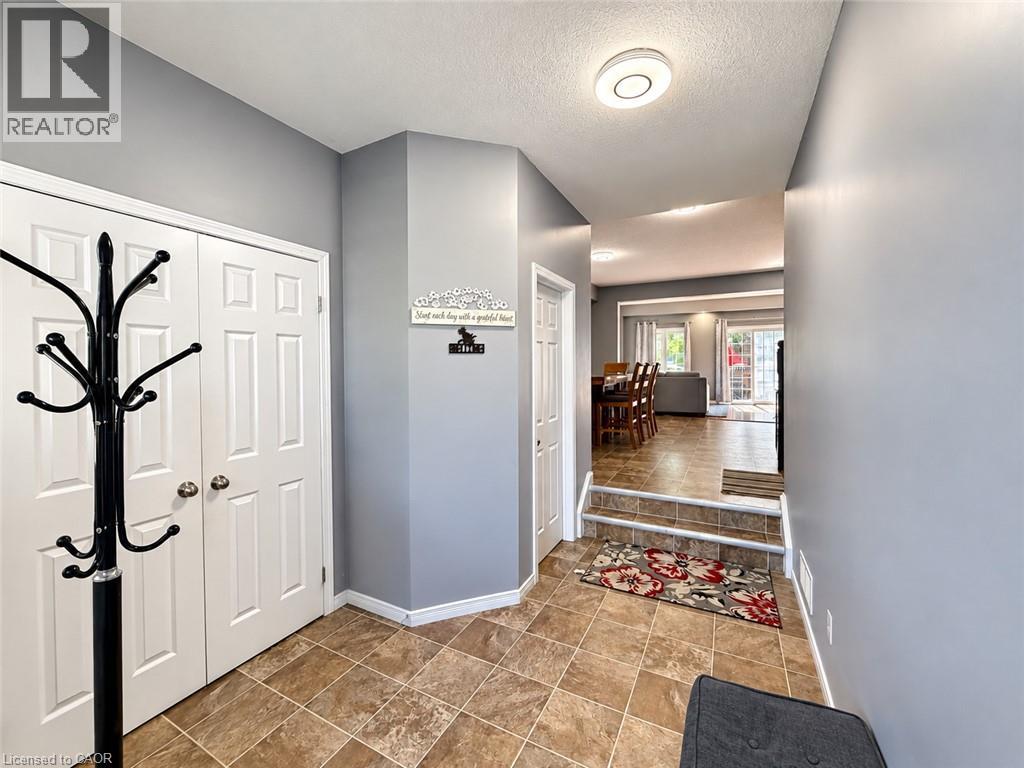 Entryway featuring tile flooring, white bi-fold doors, and a flush-mount ceiling light