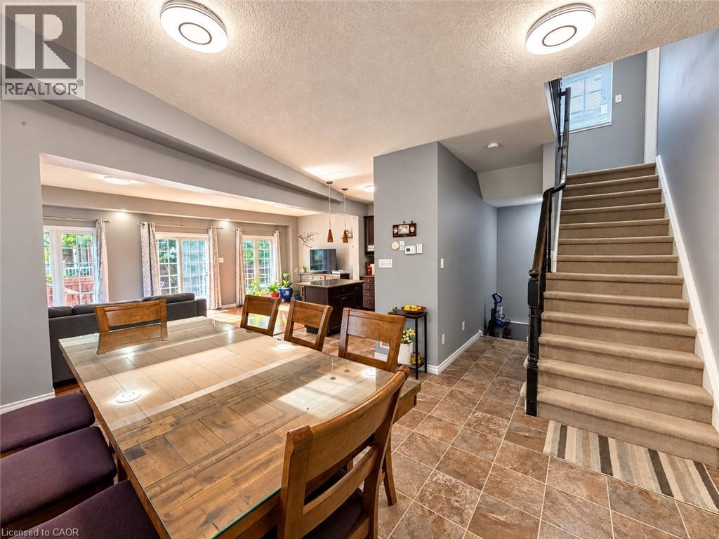 Open-concept dining area with tile flooring and direct patio access