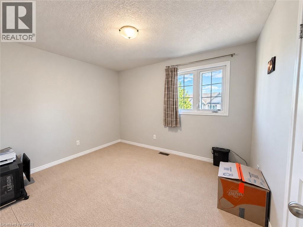Recessed ceiling light fixture, neutral wall color, window with grid pattern, wall-to-wall carpeting, and white trim