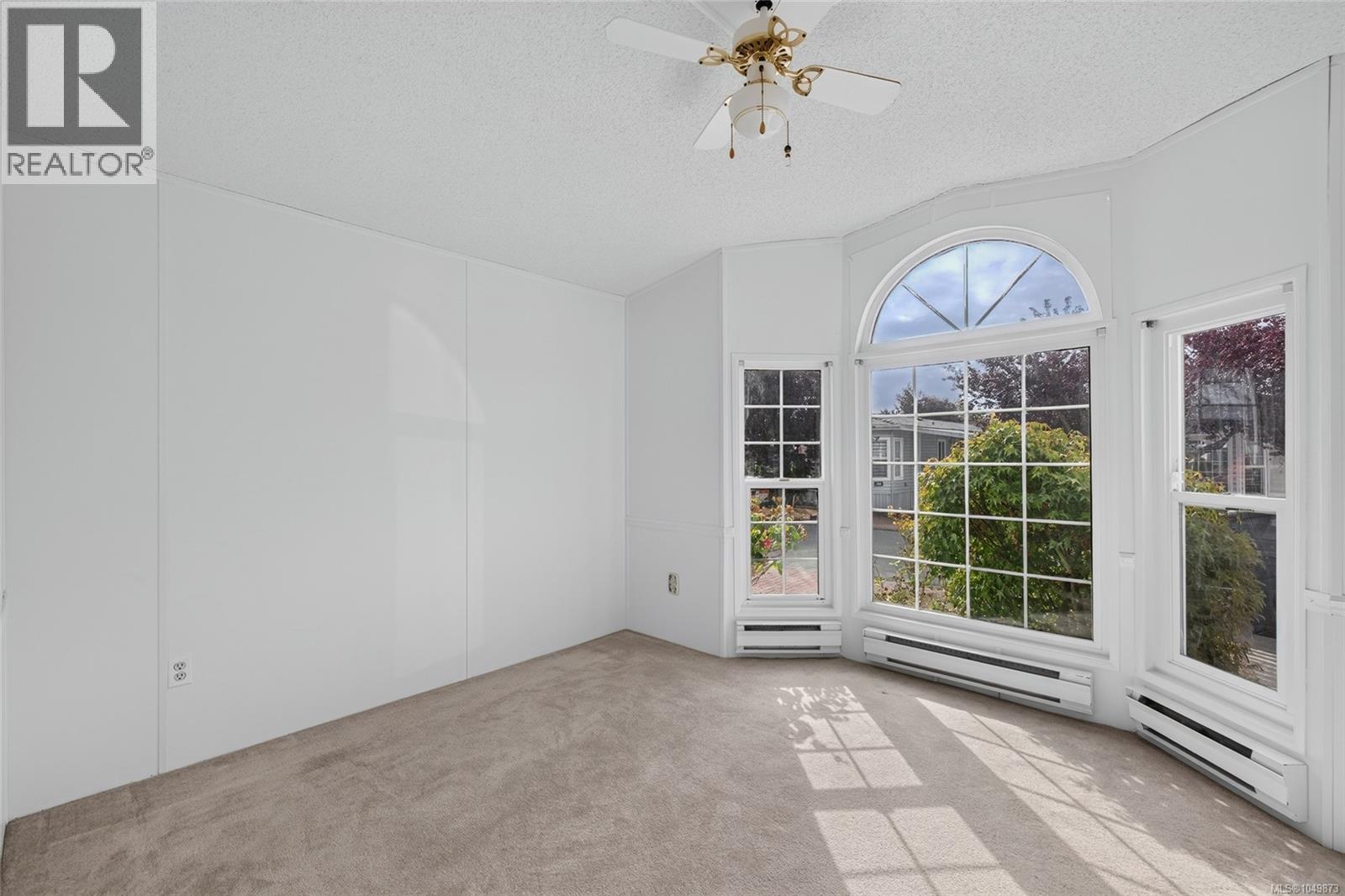 Front bedroom (secondary bedroom) with large windows & natural light