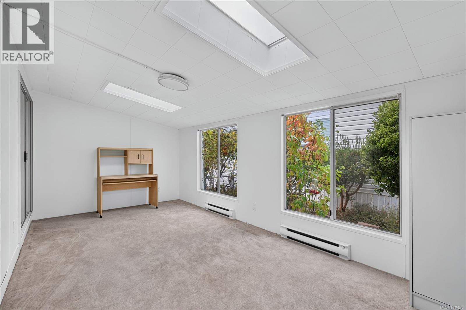 Bright family room with large windows and skylights