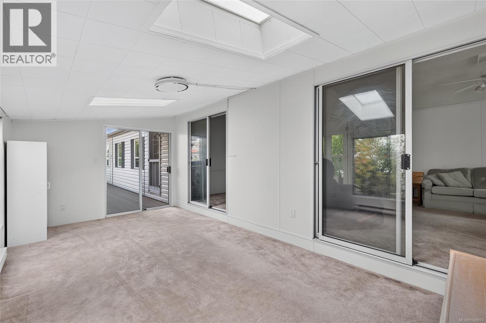 Bright family room with large windows and skylights