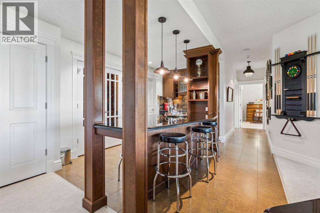 A true entertainer's retreat, the custom bar offers counter seating and flows effortlessly into the billiards and recreation areas