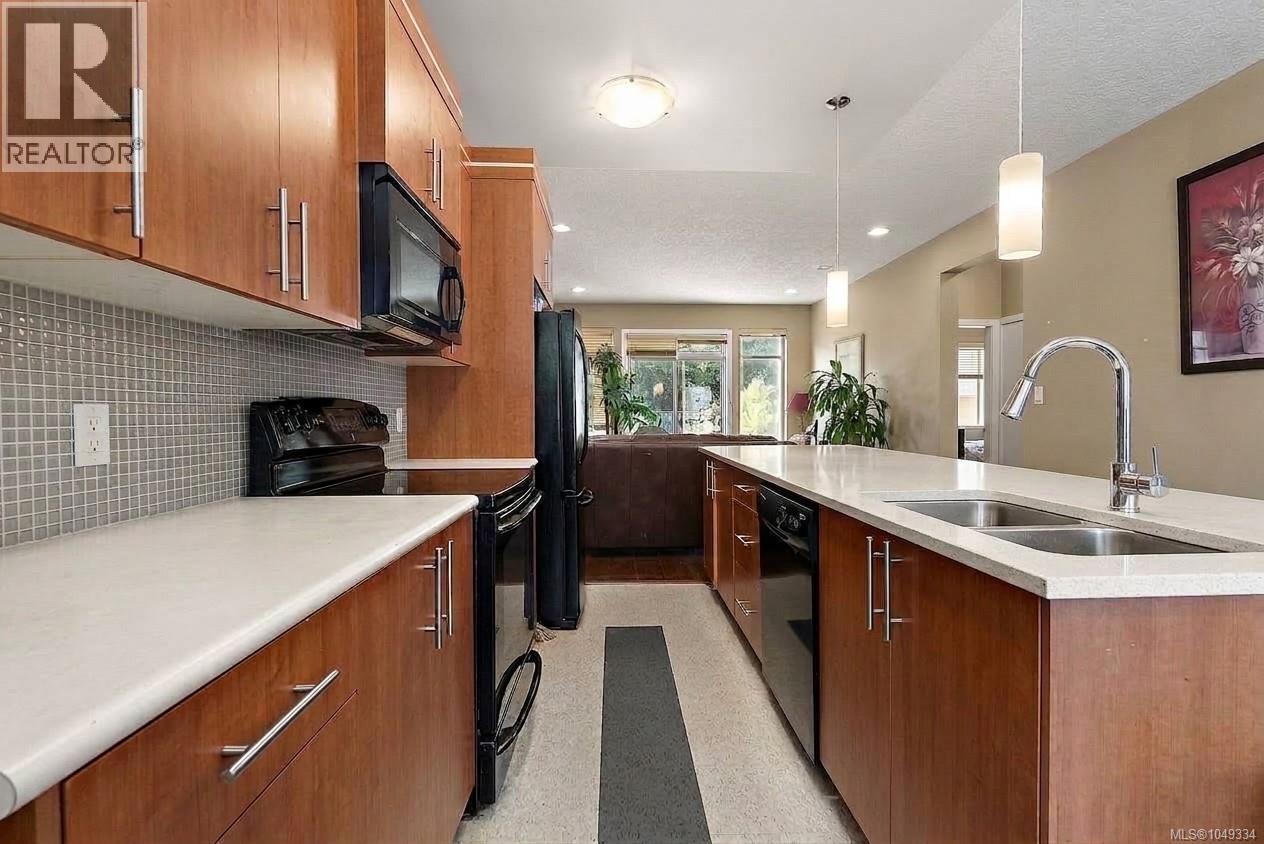 Kitchen featuring wood-finish cabinetry, light-toned countertops, and a subway tile backsplash