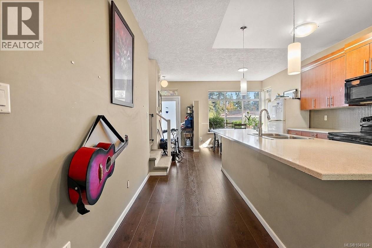 Expansive kitchen island with a light-toned countertop, complete with an undermount sink and a gooseneck faucet