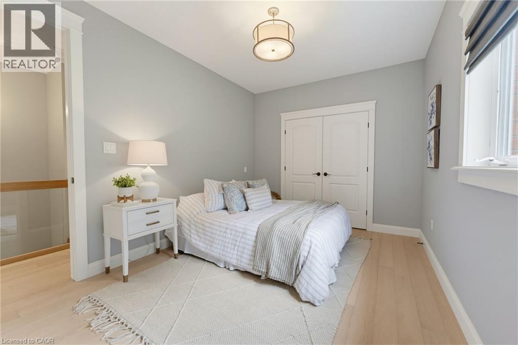 Wood-finish flooring, white trim, and a semi-flush mount ceiling light