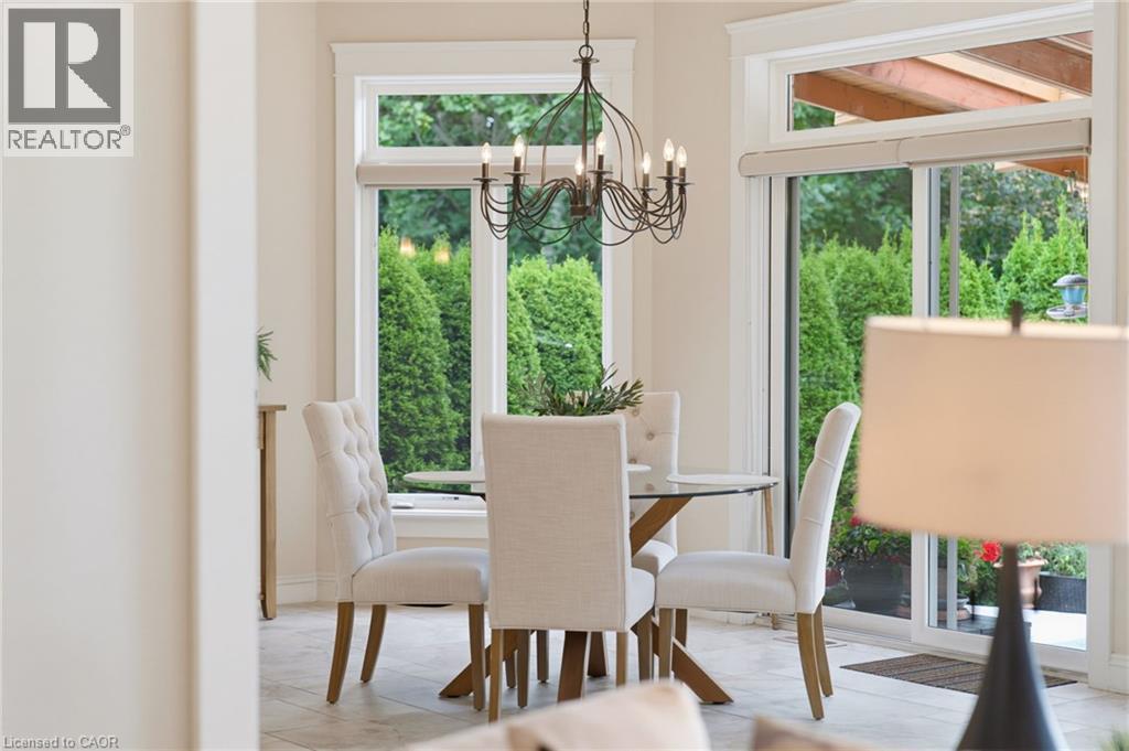 Porcelain tile flooring, large windows, sliding glass door, and an ornate chandelier