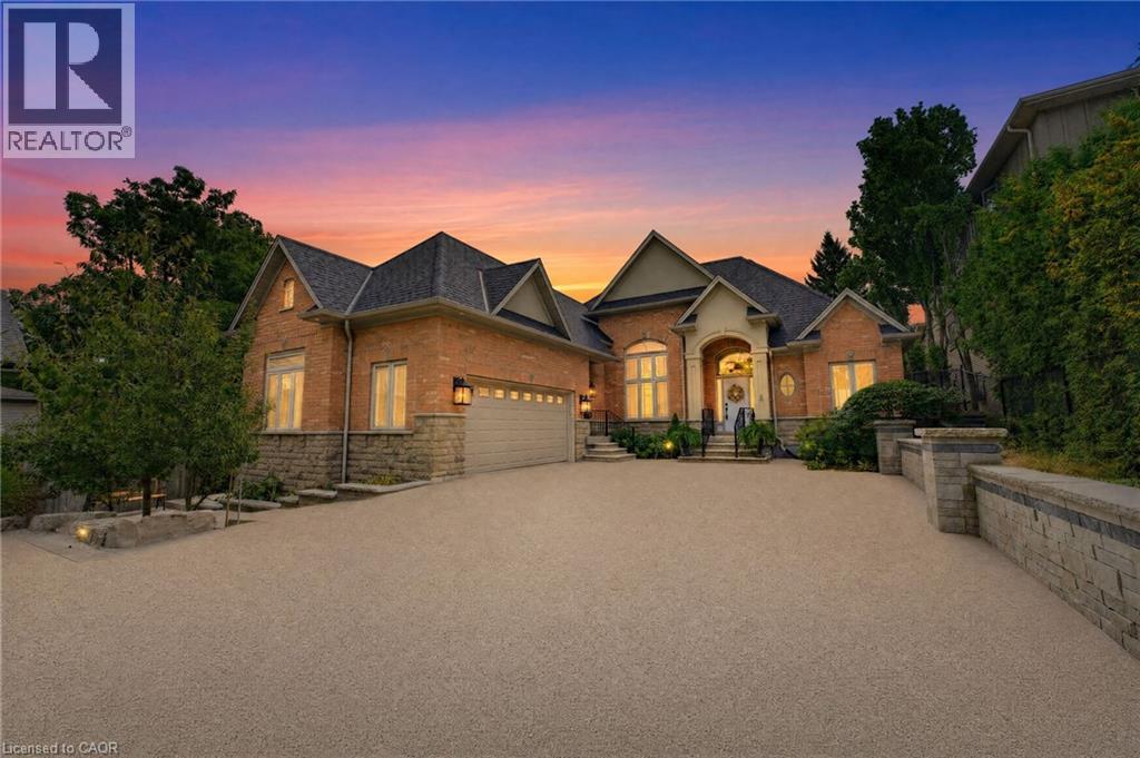 Brick and stone exterior with prominent gables and a multi-car garage