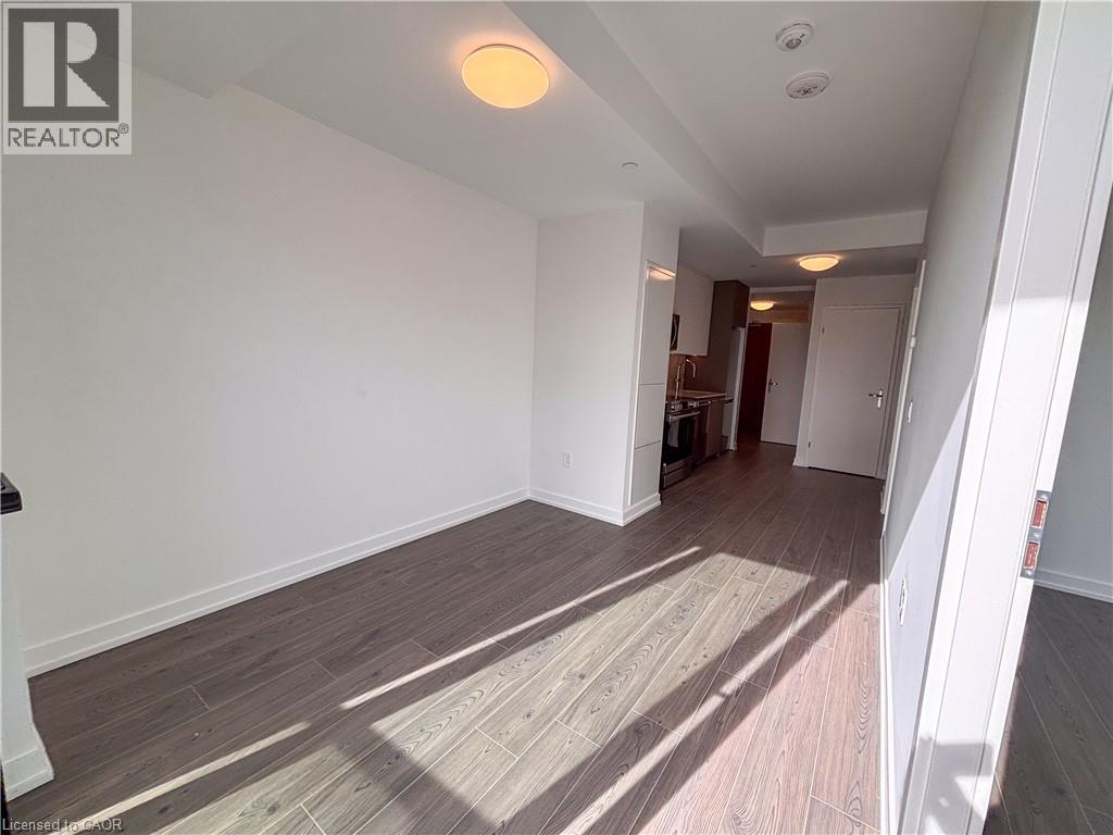Wood-finish flooring throughout, white walls, recessed lighting, and flush mount ceiling fixtures