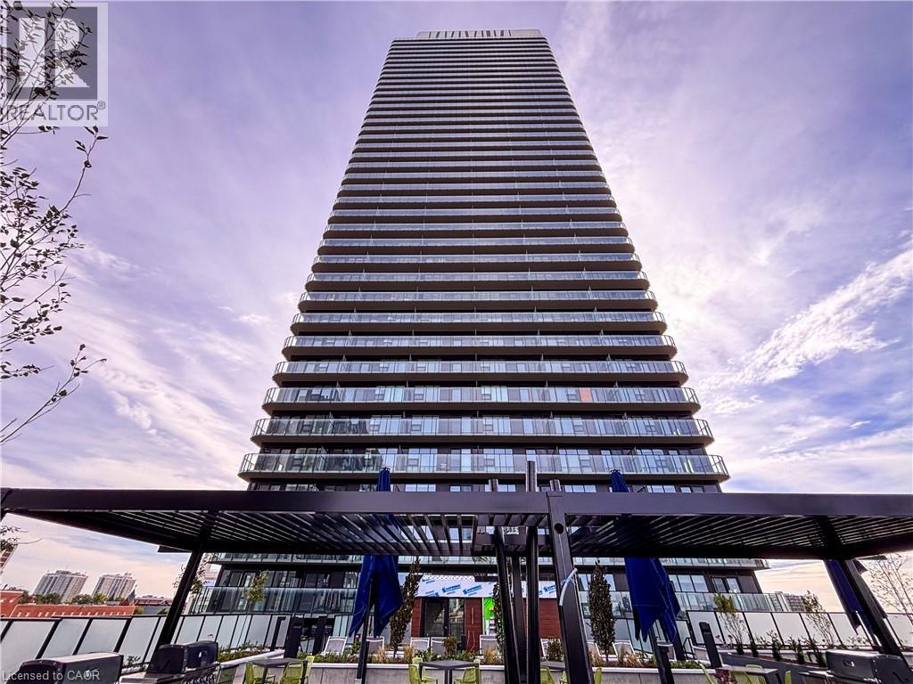 Contemporary high-rise building with a distinctive architectural design, featuring numerous glass-paneled balconies