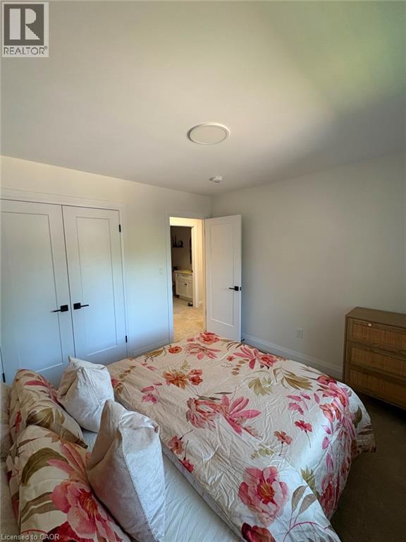 White painted walls, recessed ceiling lighting, and a white interior door with black hardware