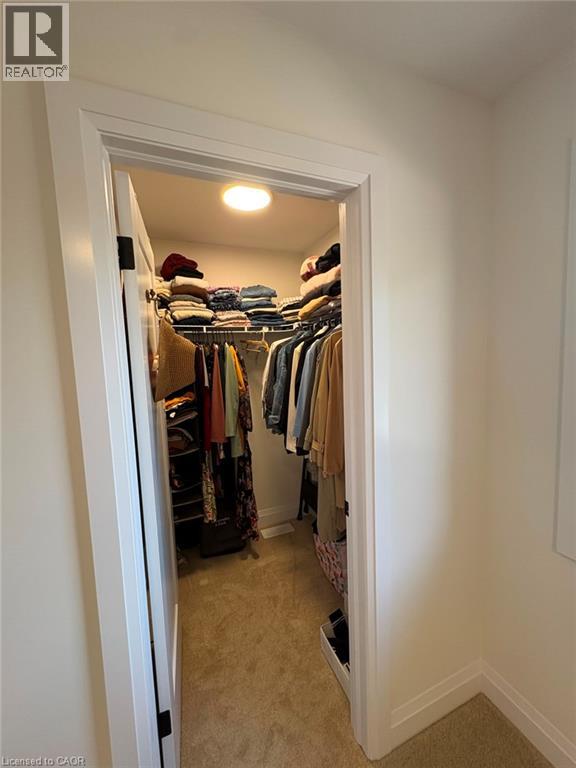 Walk-in closet with integrated shelving, hanging rods, and recessed lighting