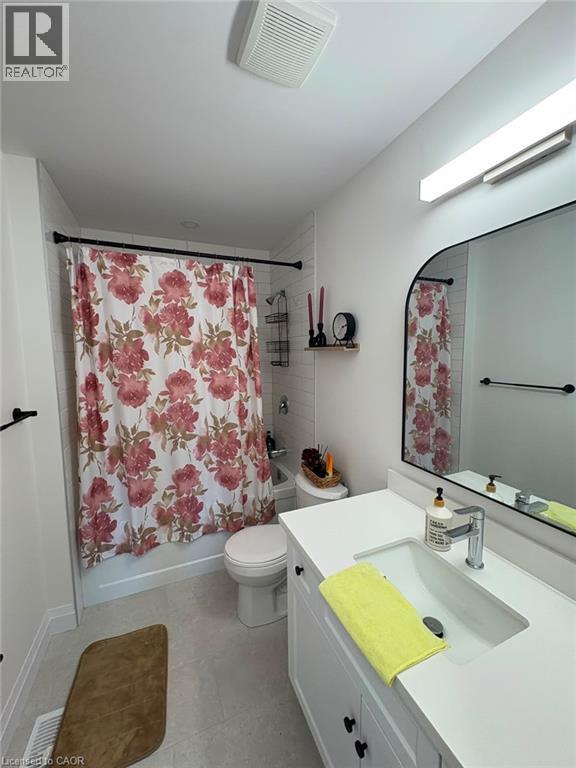 White vanity with shaker-style door fronts and black hardware