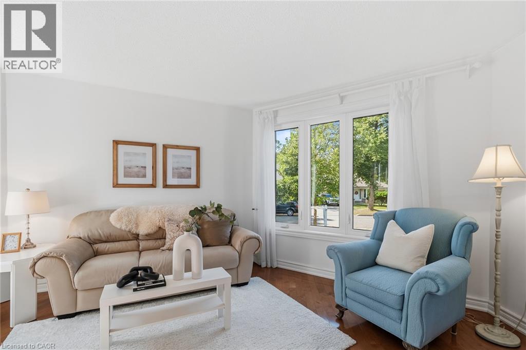 Bay window with multiple panes, crown molding, and wood-finish flooring