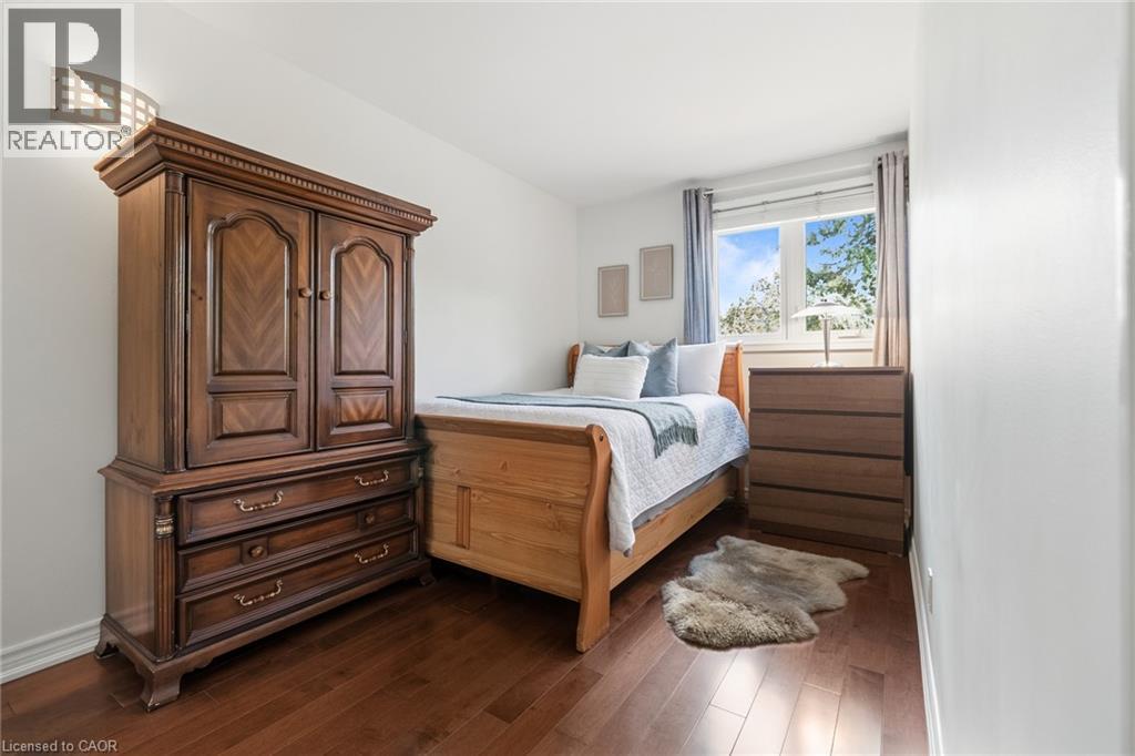 Wood-finish flooring, white walls, and a window with a natural backdrop