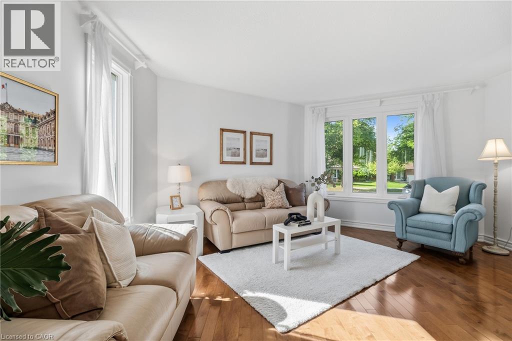 Hardwood flooring, crown molding, large picture windows, and white walls