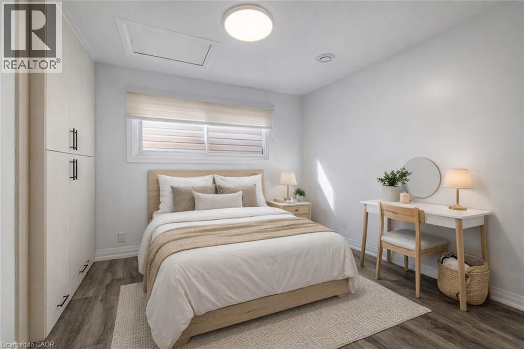 Bright room featuring wood-finish flooring and built-in cabinetry with matte black hardware