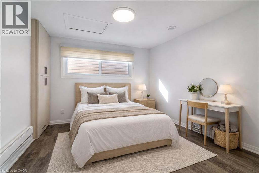 Bright interior space featuring wood-finish flooring, a built-in wardrobe with contemporary hardware, and a window with blinds